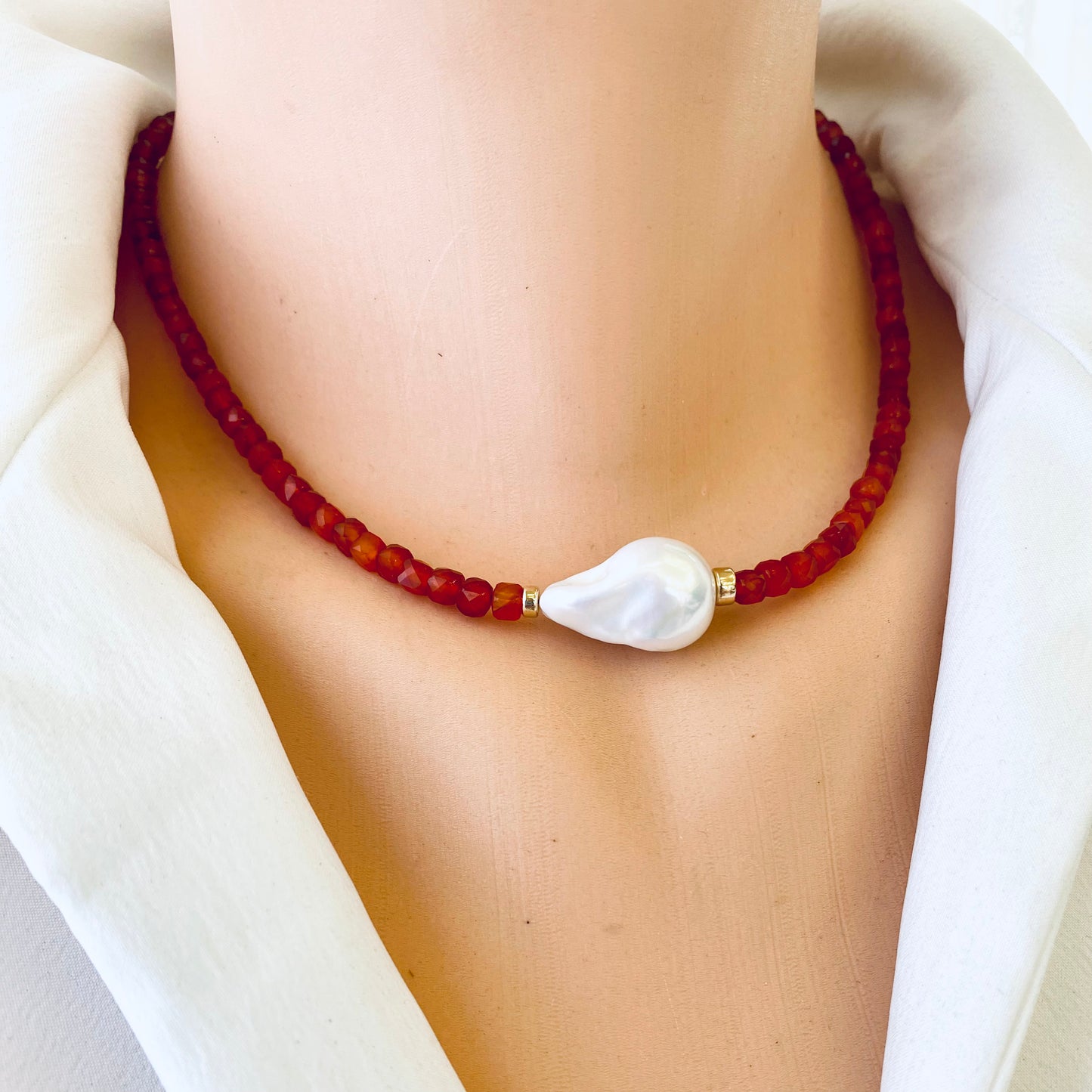 Carnelian pearl necklace featuring burnt orange carnelian beads and a stunning freshwater pearl centerpiece.