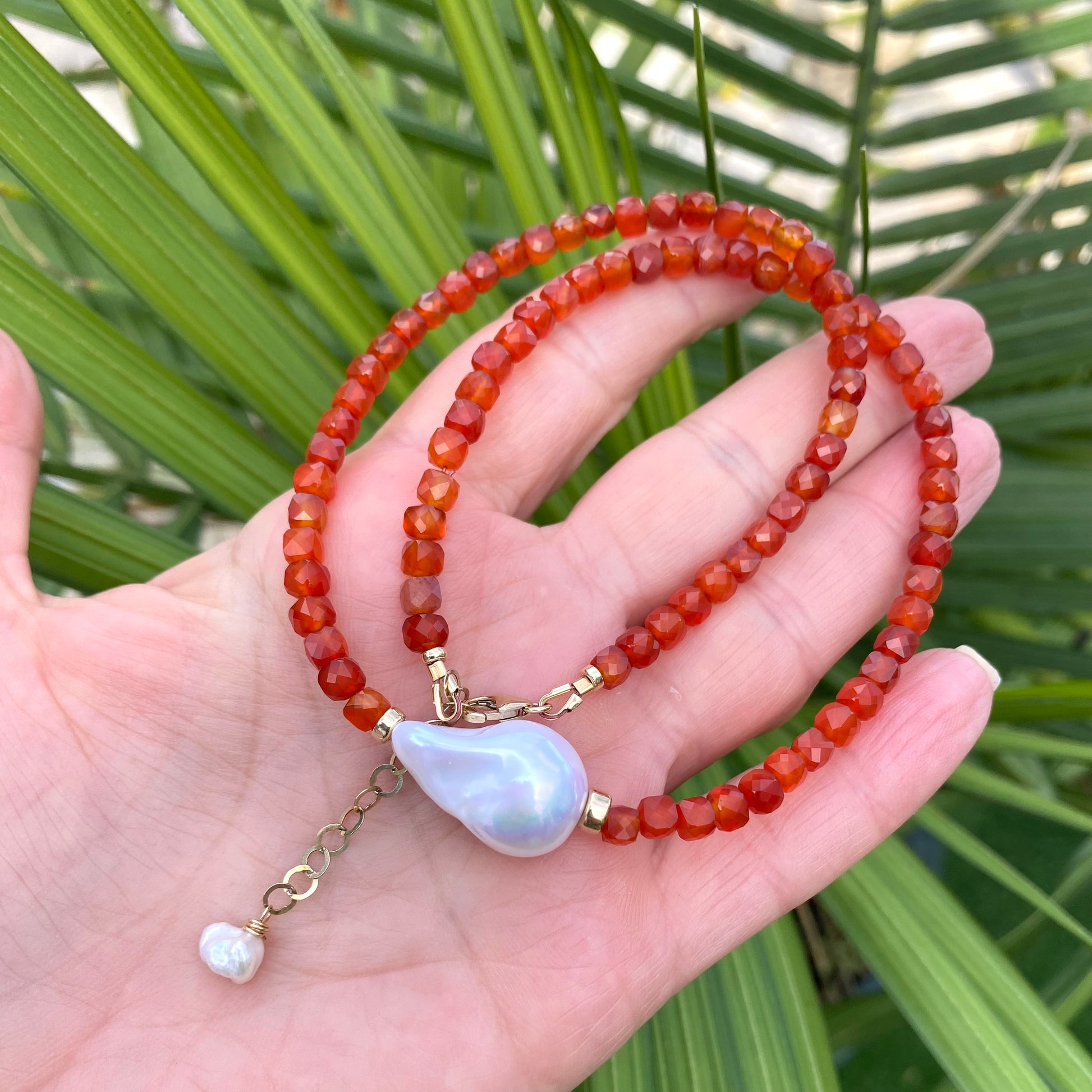 Carnelian pearl necklace featuring burnt orange carnelian beads and a lustrous pearl centerpiece.