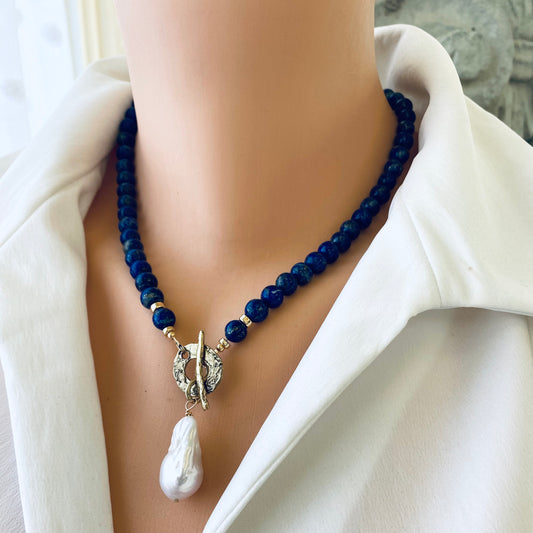 Lapis lazuli baroque pearl necklace worn on model with deep blue beads and pearl pendant