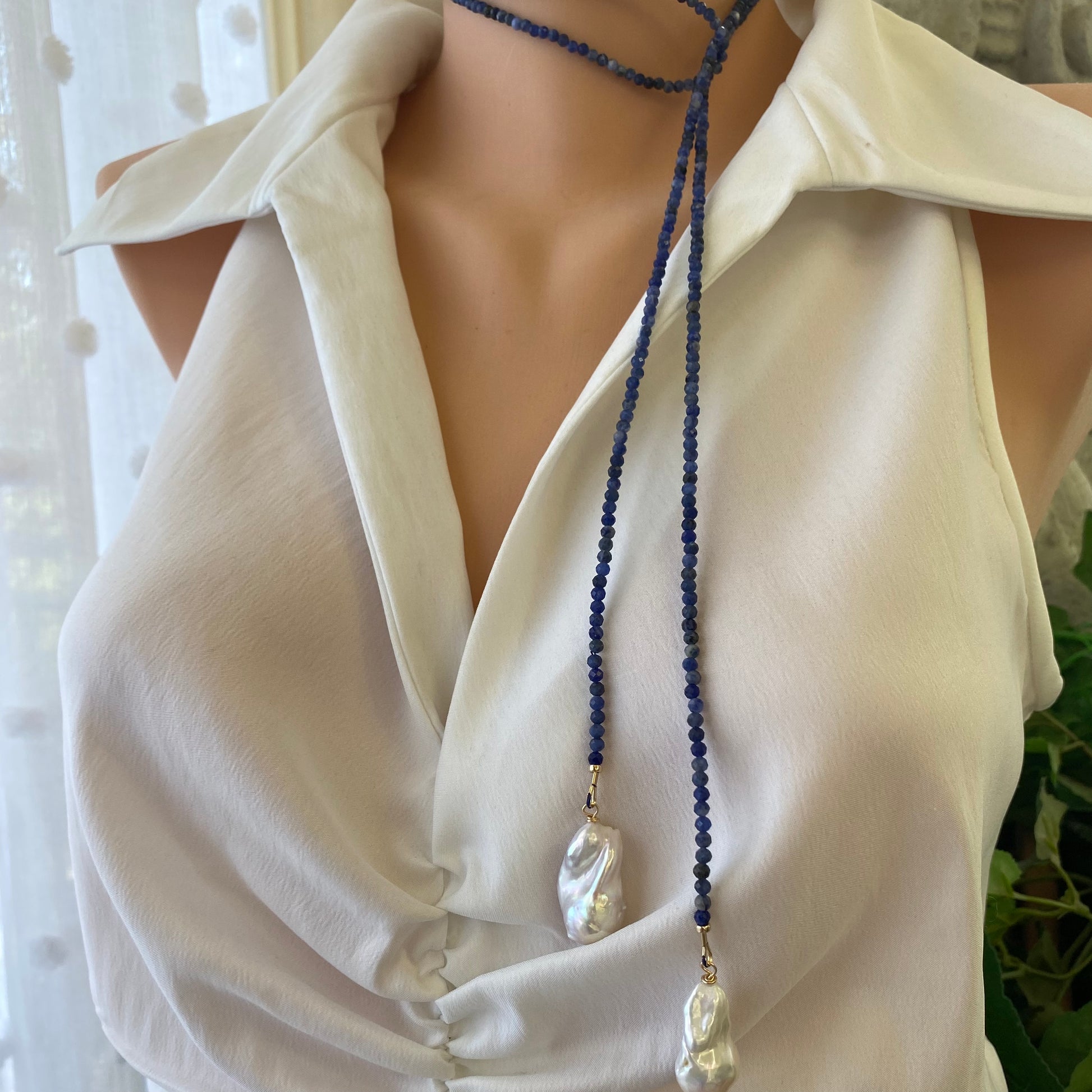 Sodalite baroque pearl lariat necklace worn long on model showing open wrap styling