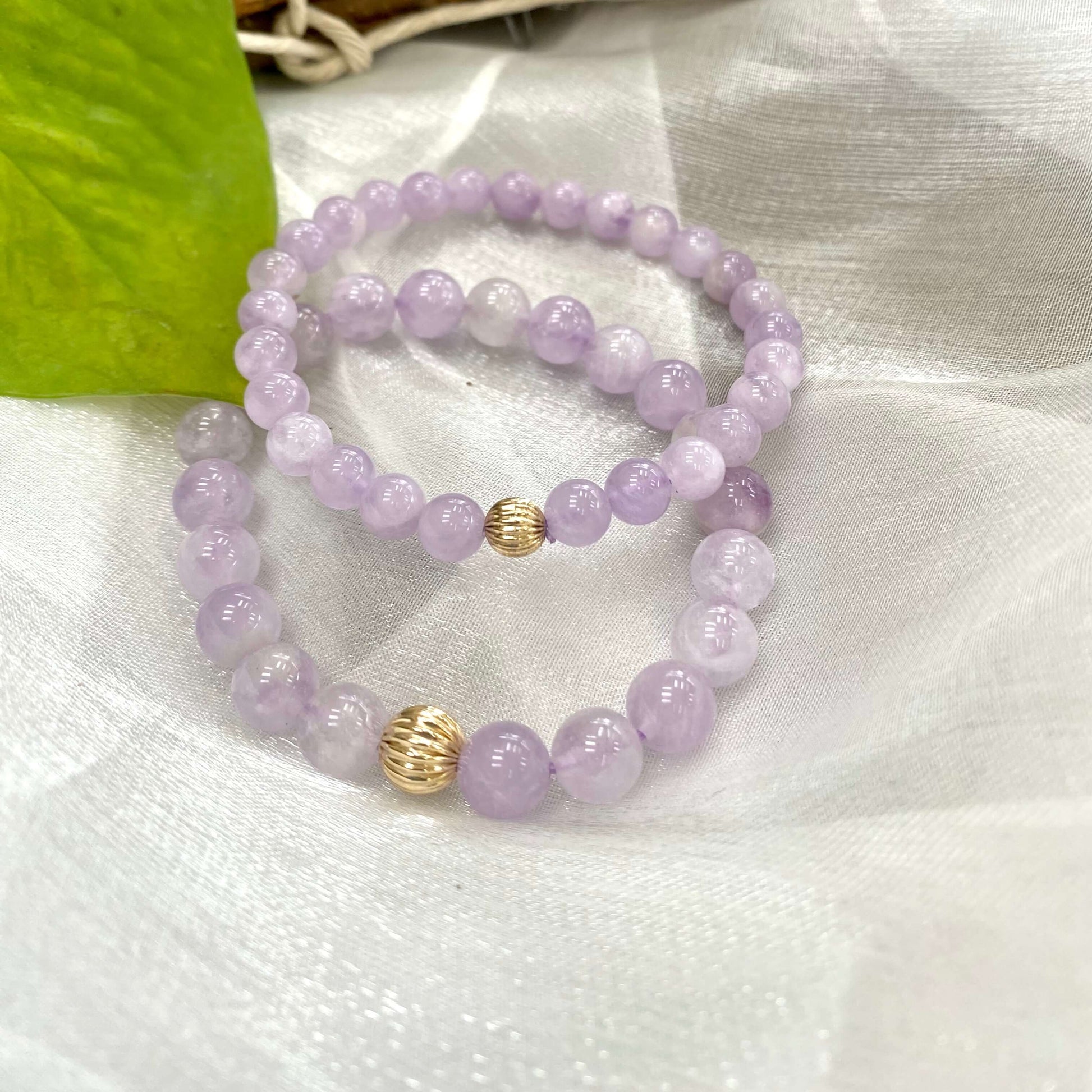 Lavender amethyst stretch bracelet showcasing 6mm and 8mm beads with 14K gold filled accents.