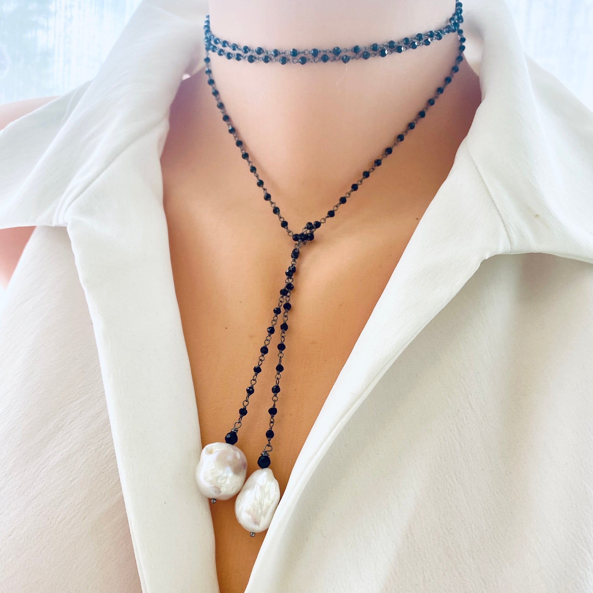 Black spinel lariat necklace worn by mannequin, double stranded choker style with baroque pearls