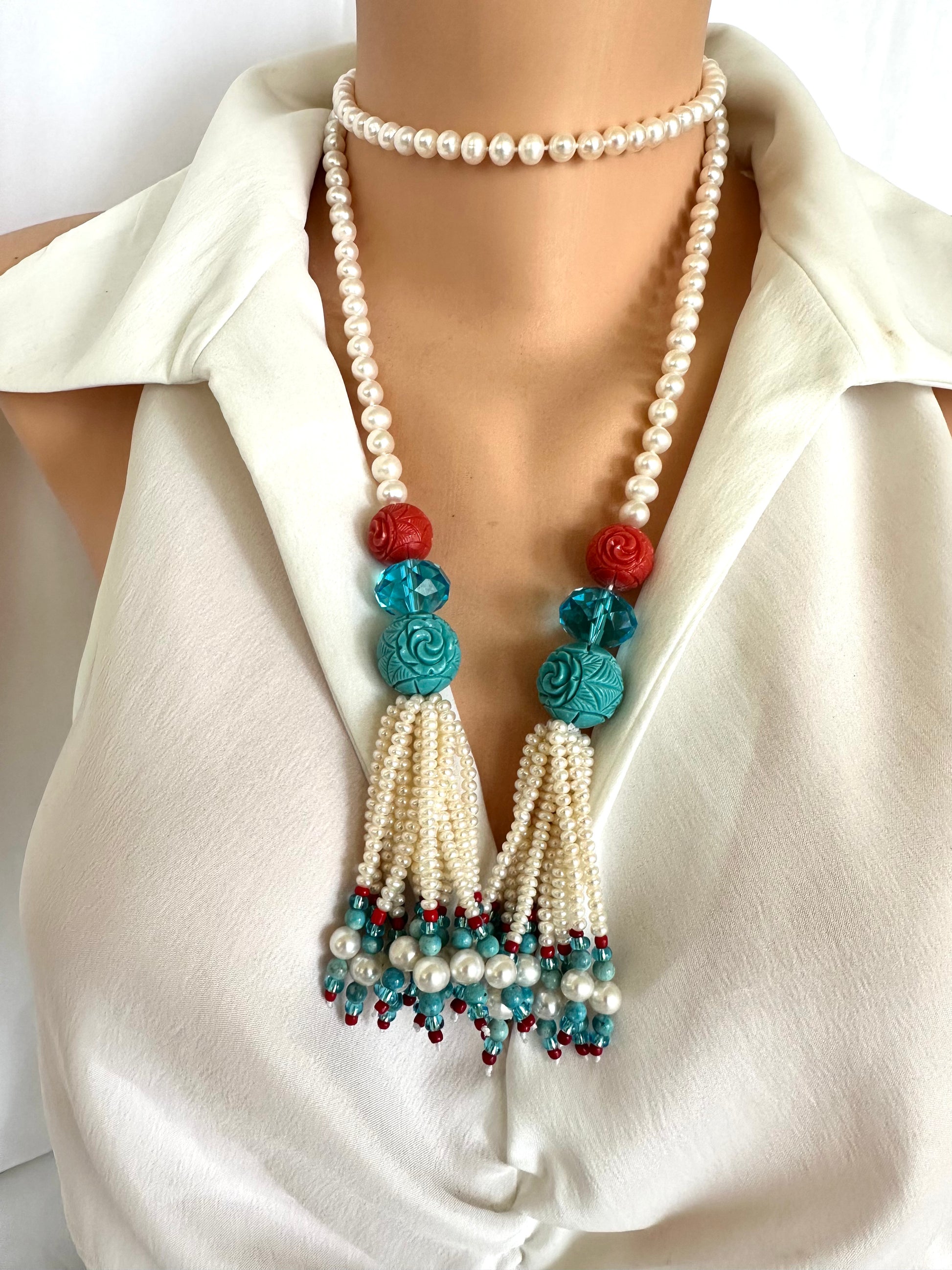 pearl coral turquoise lariat necklace showcasing handcrafted design with pearls, coral, and turquoise beads.