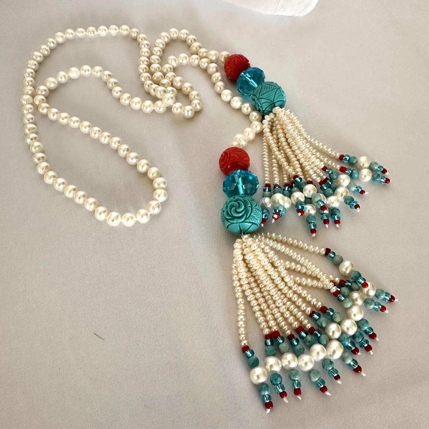 Pearl coral turquoise lariat necklace featuring freshwater pearls and coral accents, handcrafted summer design.