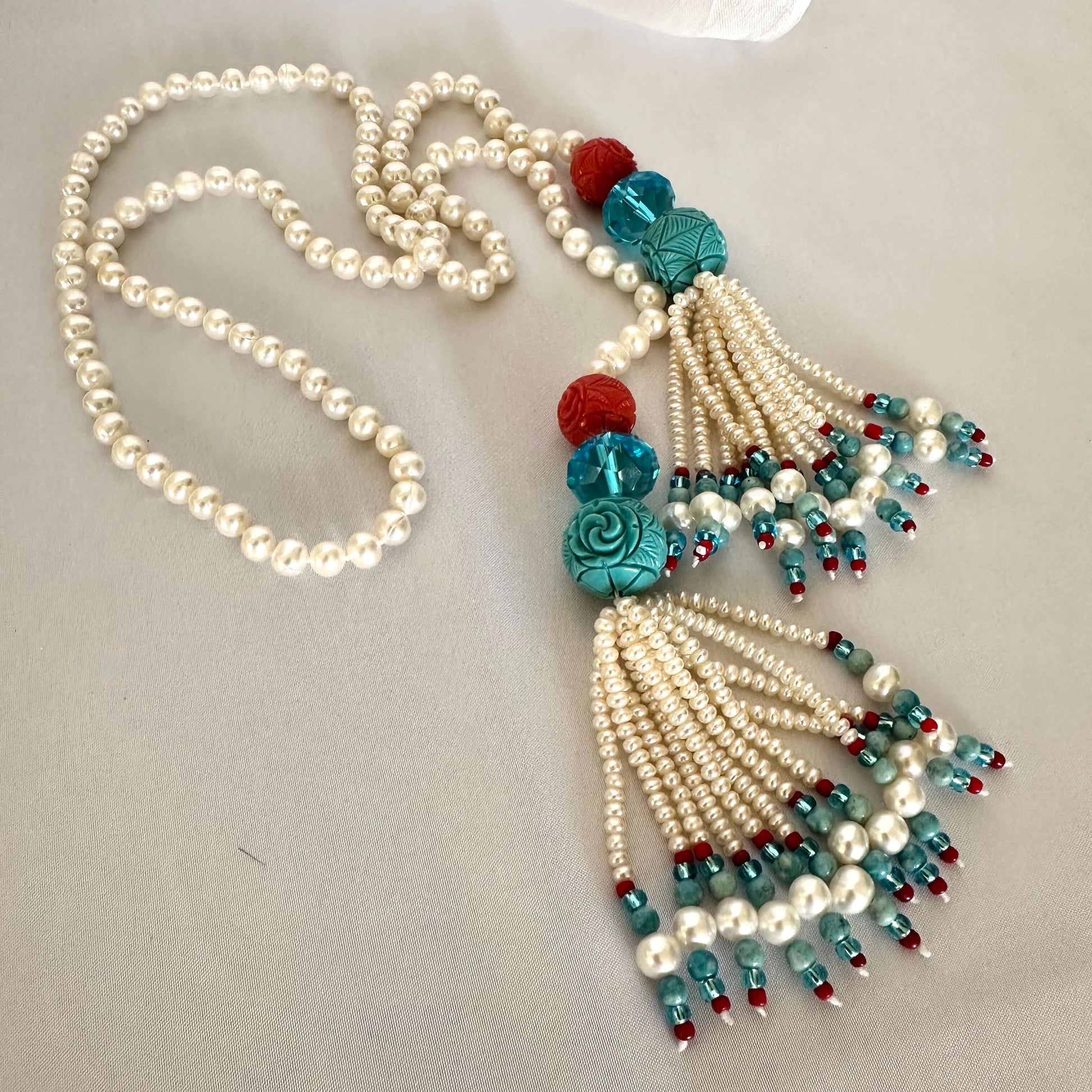 Pearl coral turquoise lariat necklace featuring freshwater pearls and coral accents, handcrafted summer design.