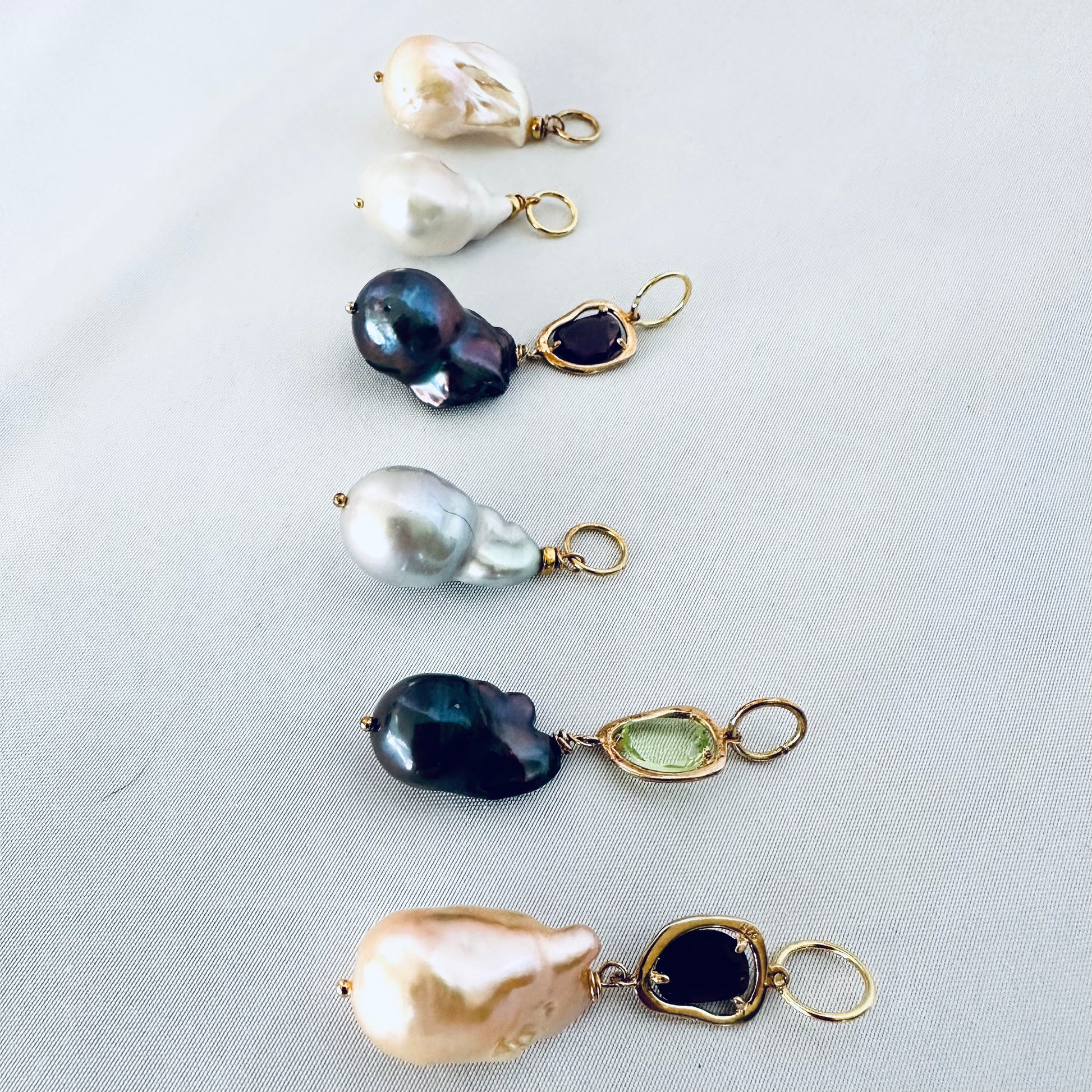 Aquamarine baroque pearl necklace featuring various pearls and gemstones in an elegant design.