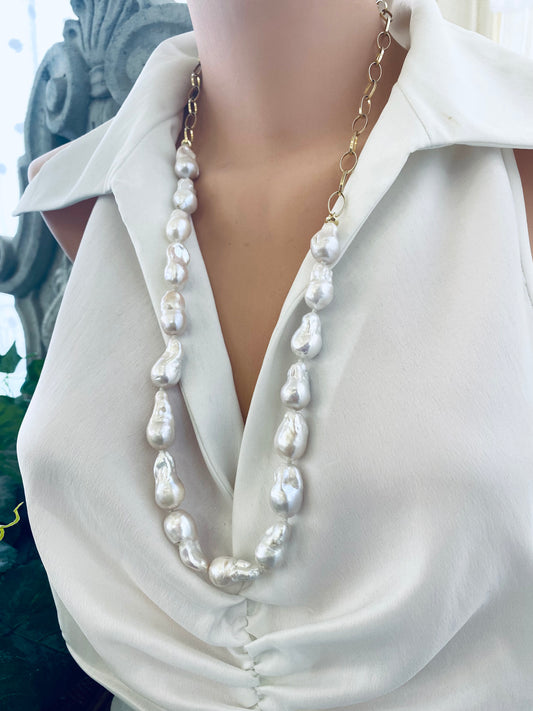 Angled view of baroque pearl gold chain necklace on mannequin — handcrafted statement jewelry with pearls and gold chain by Loulia Pearl Jewelry