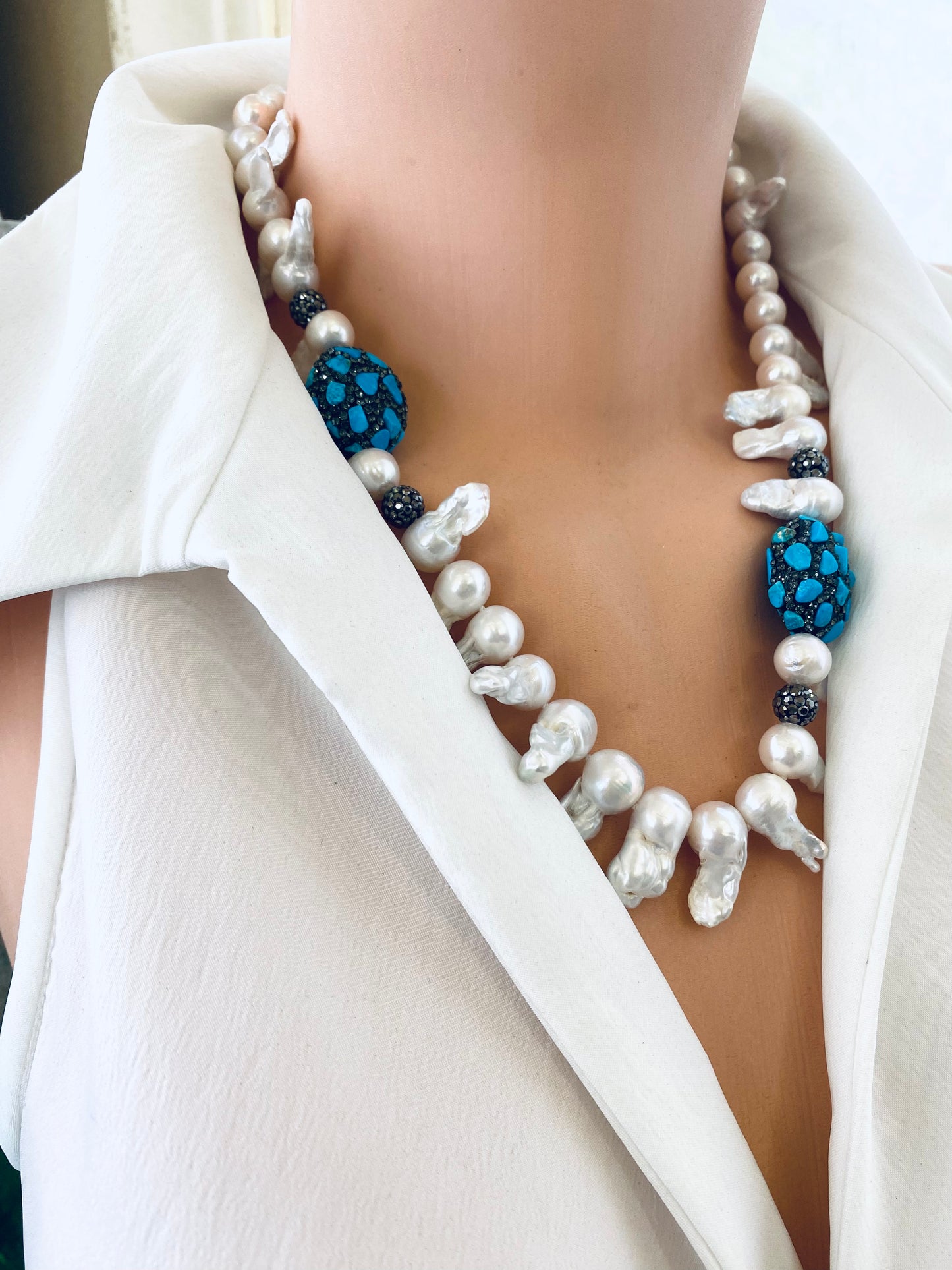 Close up baroque pearl jellyfish necklace draped on mannequin handmade in Canada