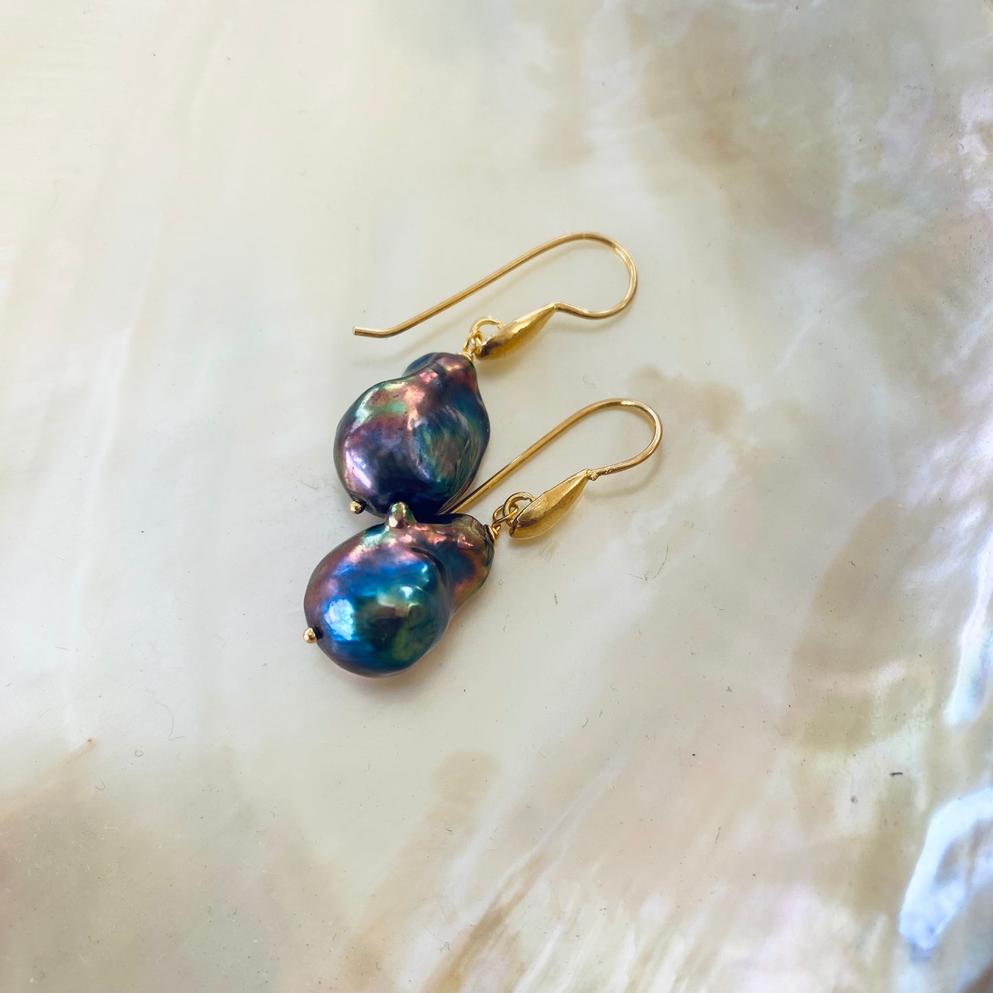 Gold vermeil baroque pearl drop earrings showing natural pearl texture on white background