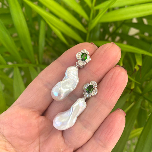 Green diopside baroque pearl drop earrings held in hand against green leaves — handcrafted gemstone jewelry by Loulia Pearl Jewelry