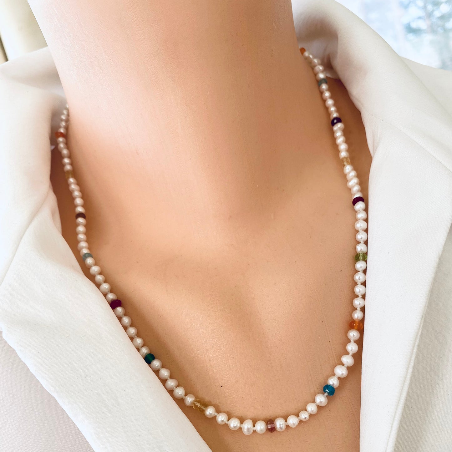 Rainbow gemstone pearl necklace worn at collarbone with delicate freshwater pearls
