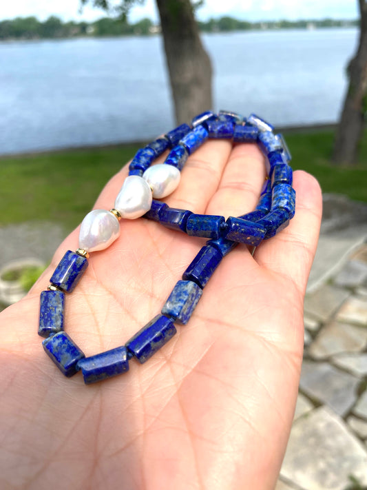 Lapis lazuli pearl necklace held in hand showing tube beads and pearl accents, handmade Canadian jewelry