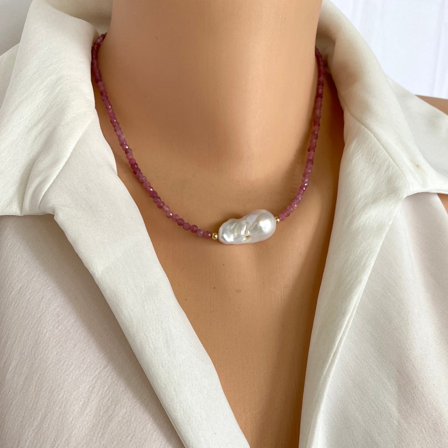 Pink Tourmaline Baroque Pearl Necklace showcased on a model, featuring pink tourmaline beads and a baroque pearl.