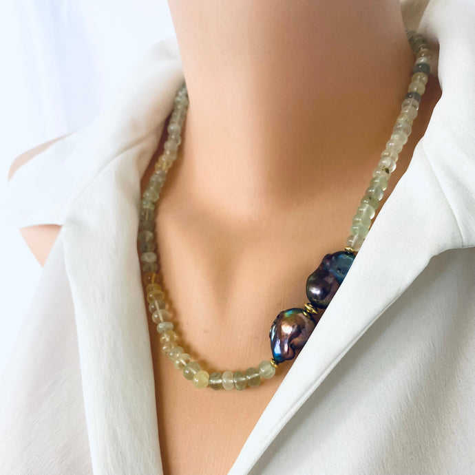 this hand-knotted necklace features beautifully shaded prehnite beads in calming tones, accented by two striking black baroque pearls placed off-center for an eye-catching asymmetry.