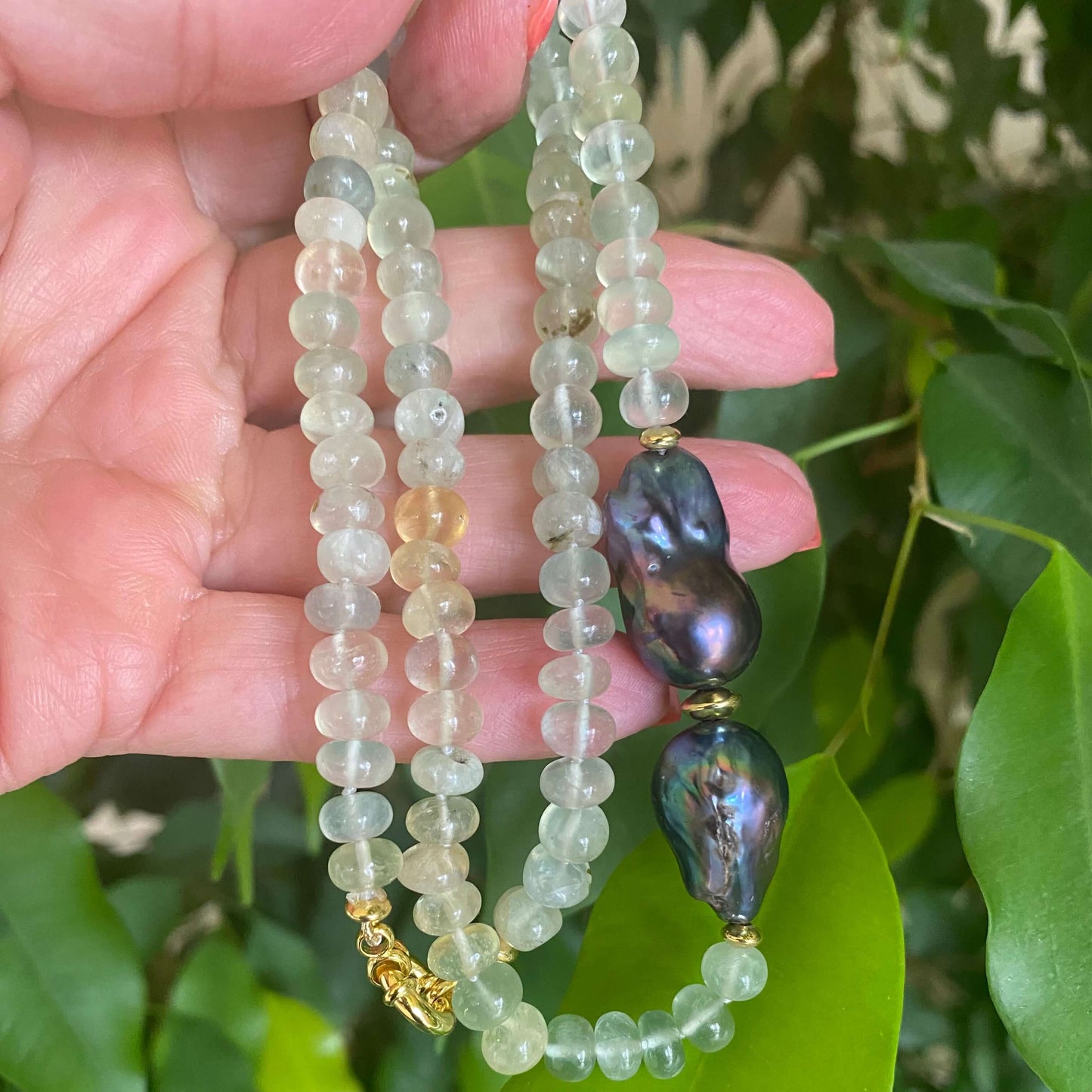 Prehnite and Black Baroque Pearl Necklace showcasing translucent greens and striking black pearls, handcrafted design.