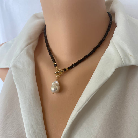 Black tourmaline choker necklace with pearl charm worn on a mannequin, showcasing its elegant design and refined style.