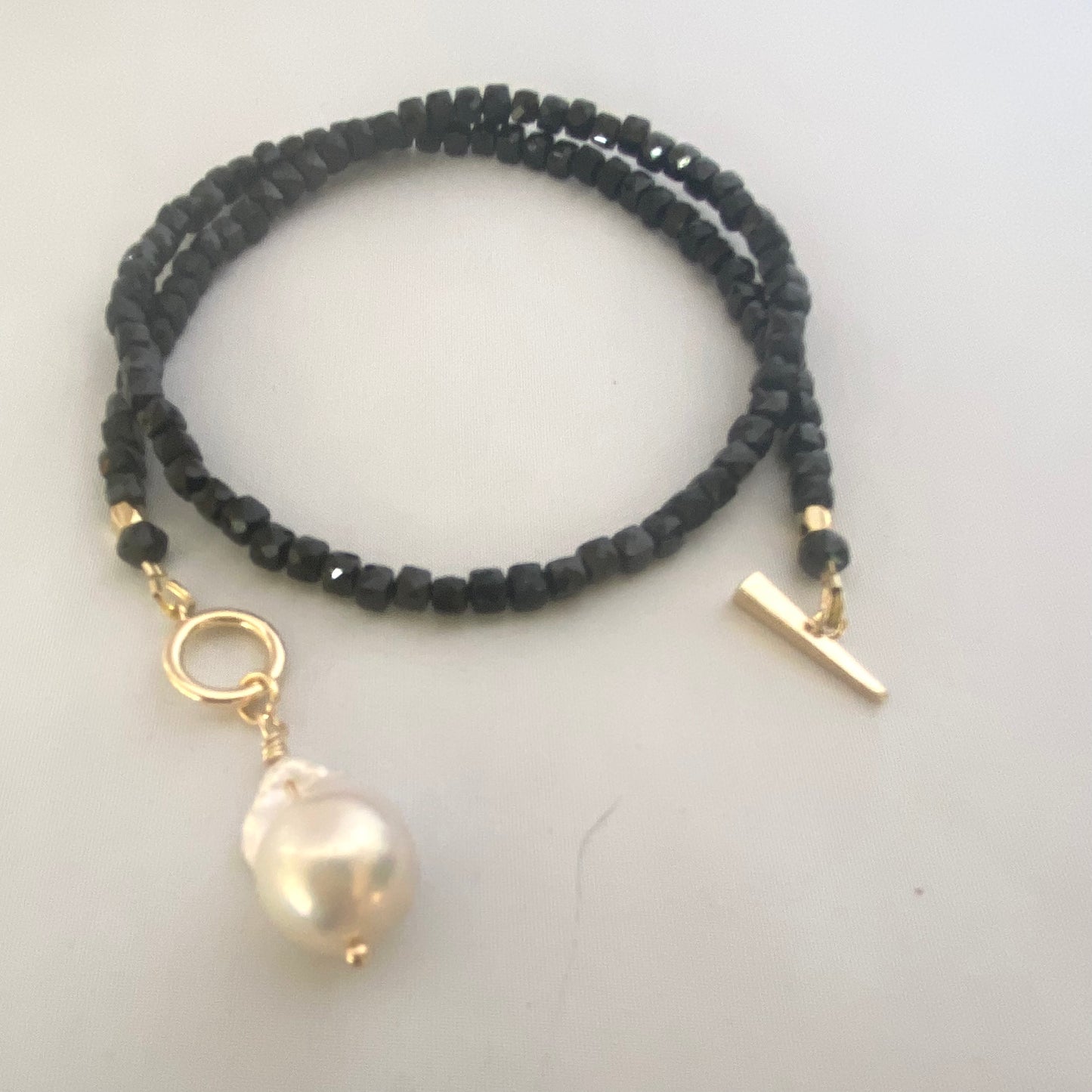 Black Tourmaline Choker Necklace with Pearl Charm showcasing sparkling faceted black tourmaline beads.