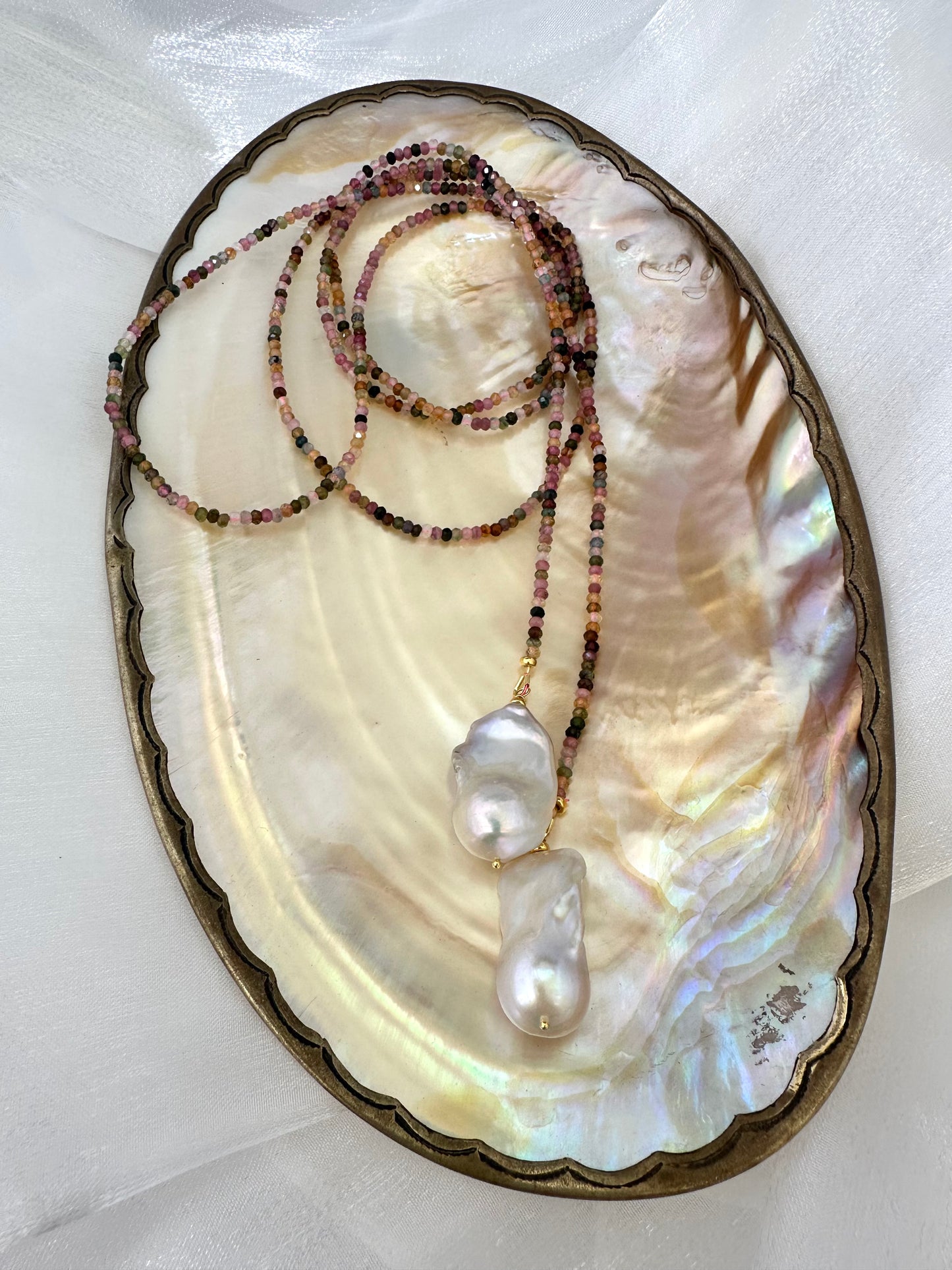 Multi Tourmaline Baroque Pearl Lariat Necklace displayed on pearl shell background — handcrafted gemstone and pearl necklace by Loulia Pearl Jewelry