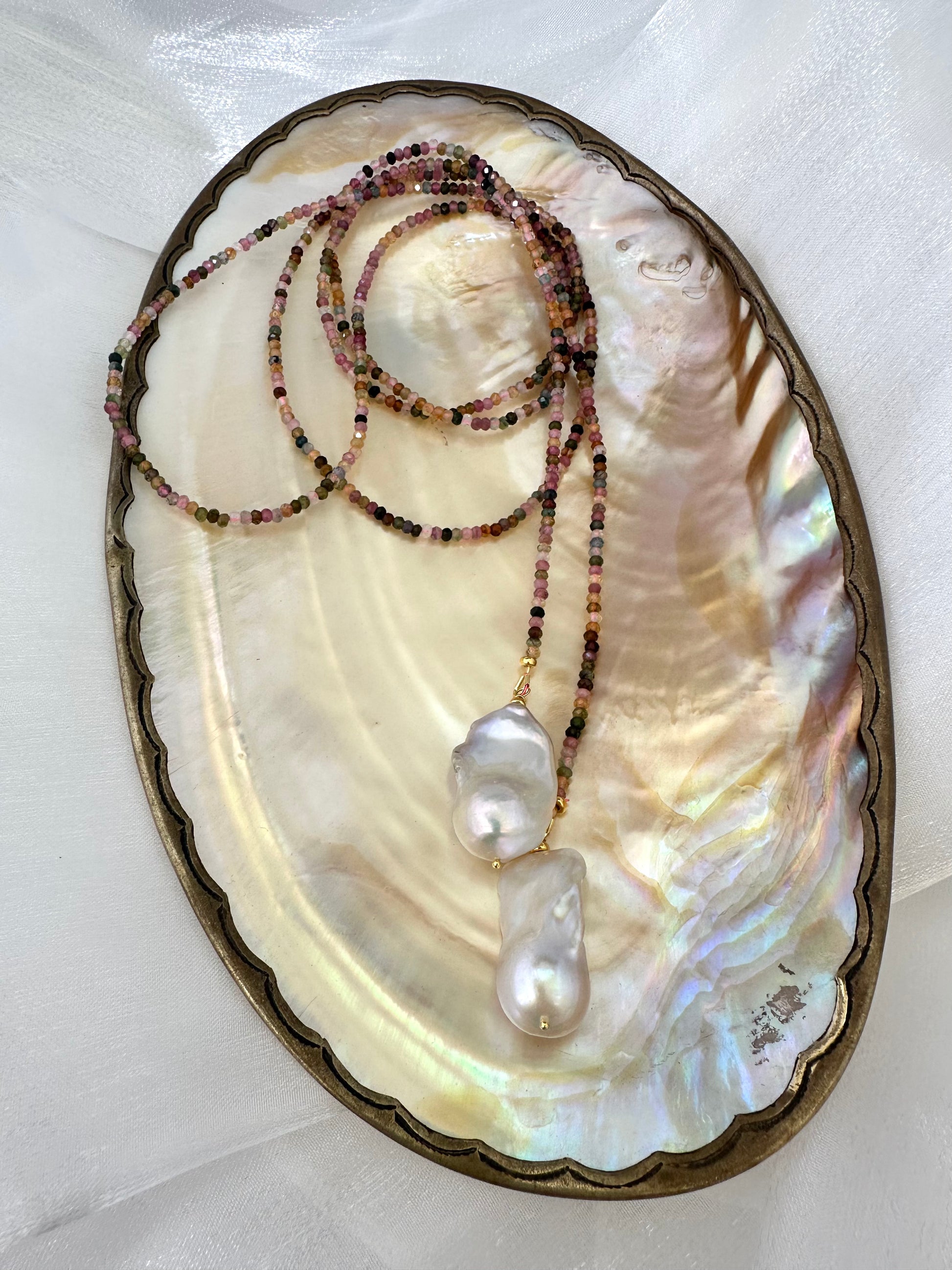 Multi Tourmaline Baroque Pearl Lariat Necklace displayed on pearl shell background — handcrafted gemstone and pearl necklace by Loulia Pearl Jewelry