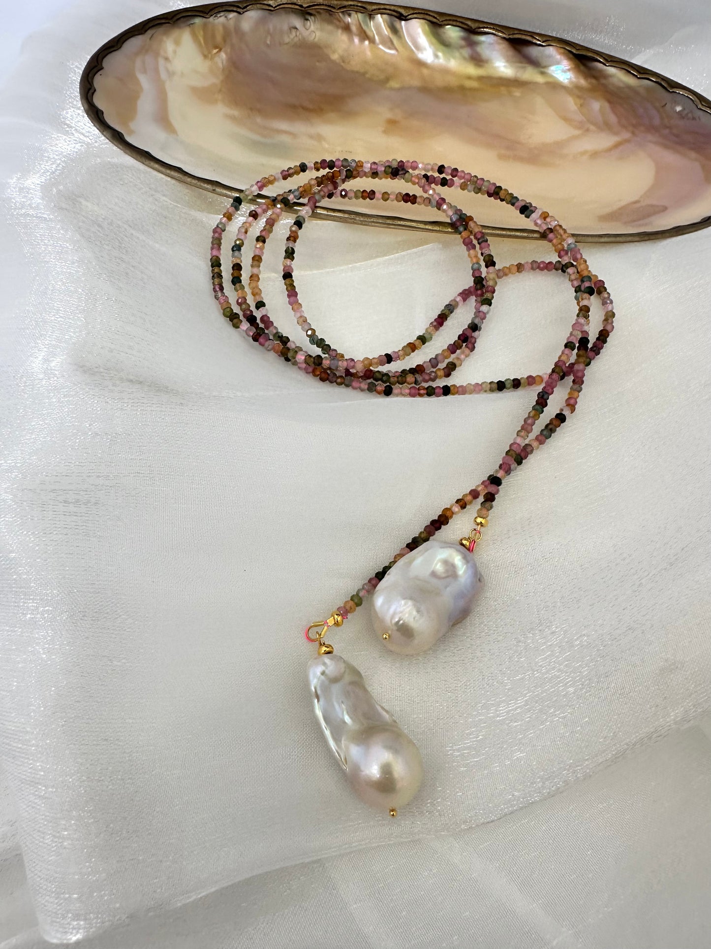 Close-up of Multi Tourmaline Baroque Pearl Lariat Necklace on white background — faceted tourmaline beads and baroque pearls handcrafted by Loulia Pearl Jewelry