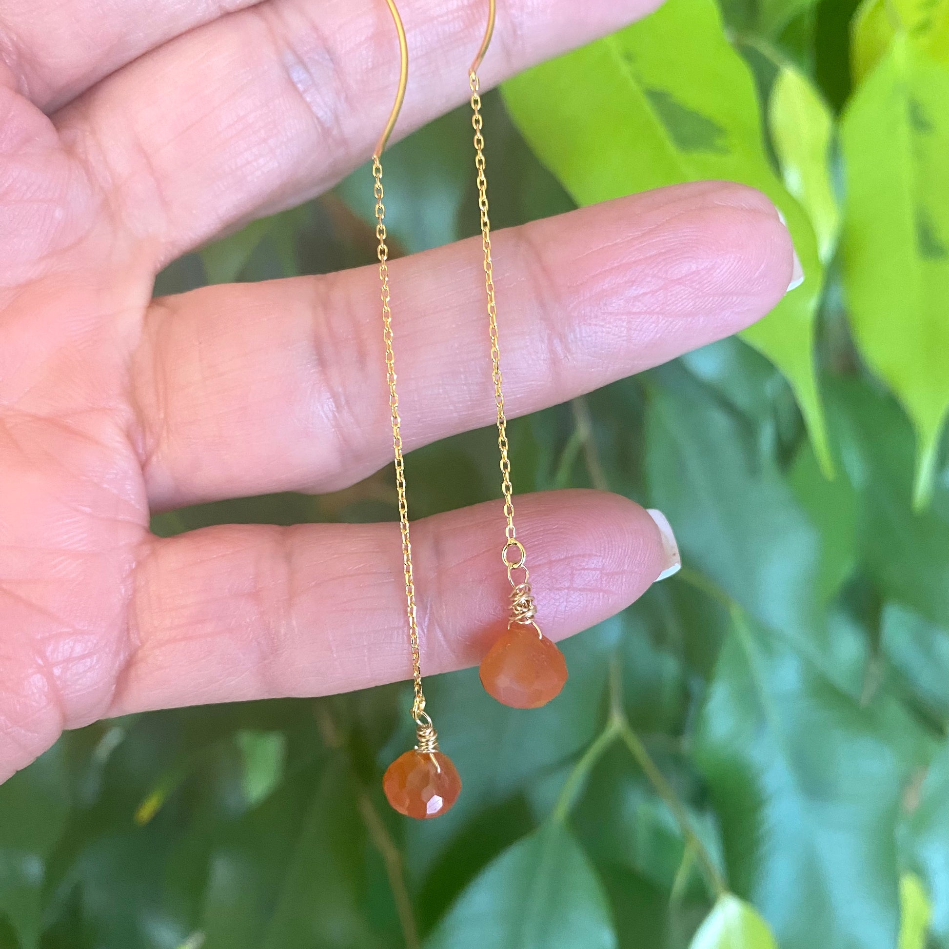 Handmade carnelian threader earrings with briolettes, showcasing bright orange hues and lightweight design.