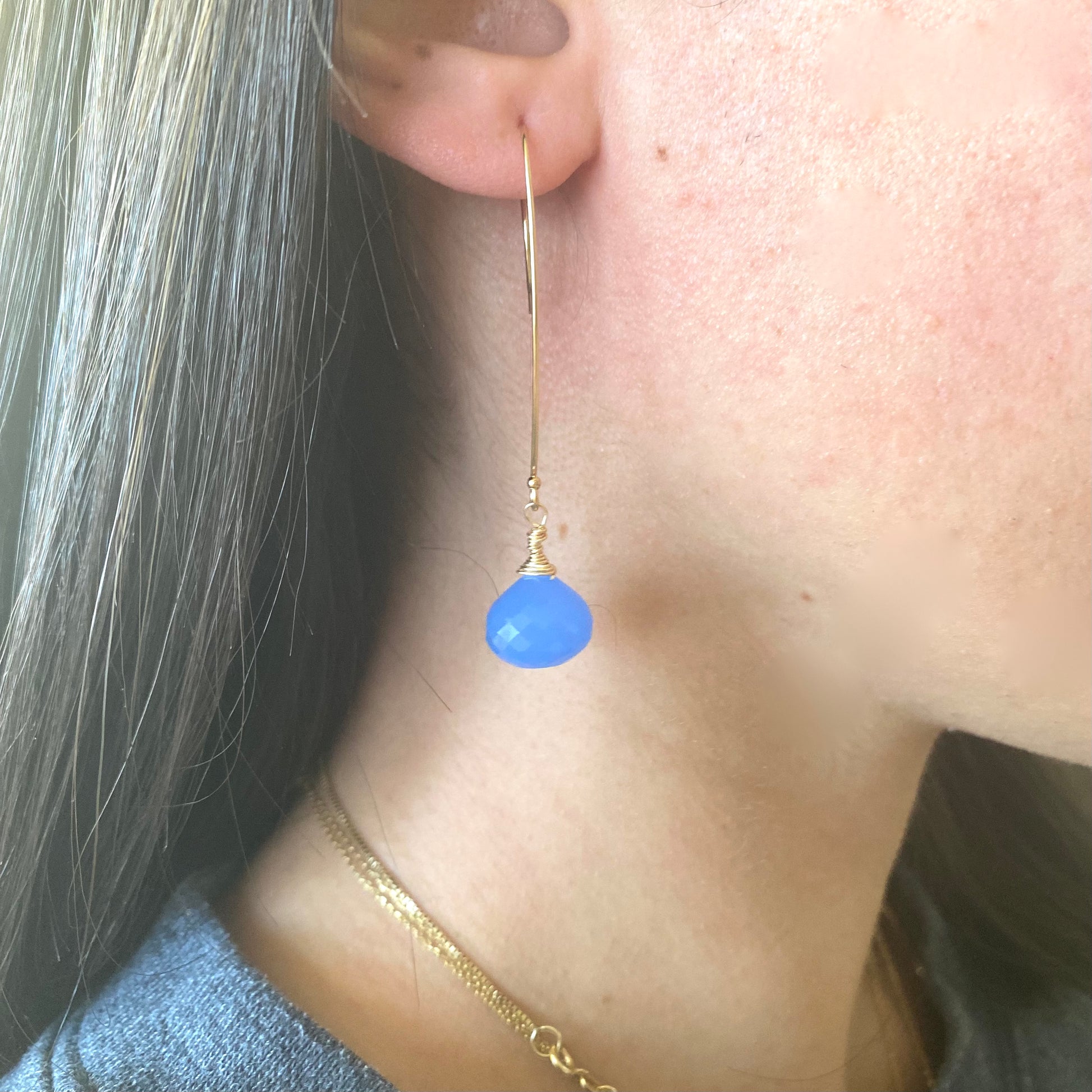 Chalcedony threader earrings with blue briolettes worn by a model, showcasing their elegant design and craftsmanship.