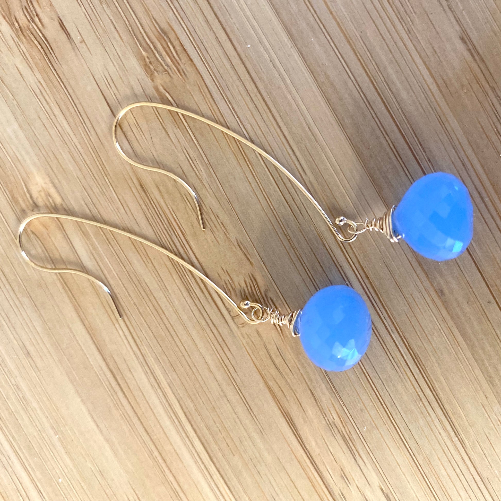 Chalcedony threader earrings featuring blue briolettes, handcrafted with graceful design and elegant movement.