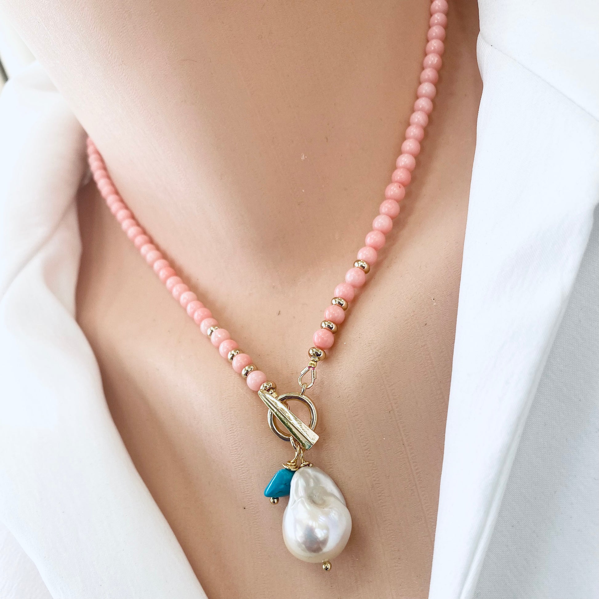 Pink coral toggle necklace featuring baroque pearl and turquoise charm, perfect for summer style.