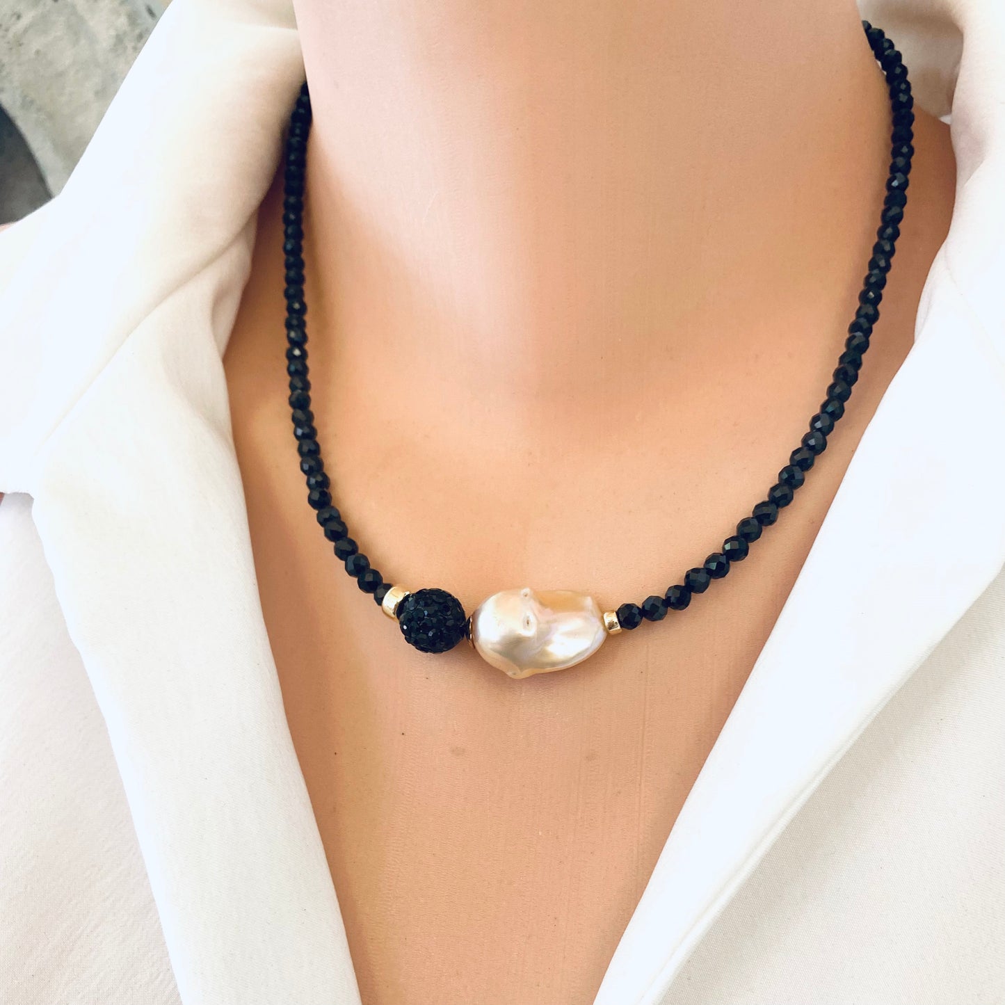 Black spinel pearl necklace worn on mannequin, front close-up