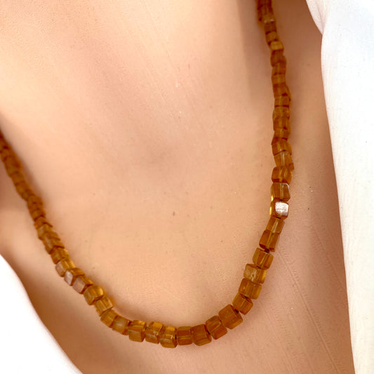 Hessonite garnet necklace showcasing geometric design with warm golden-yellow tones and a magnetic clasp.