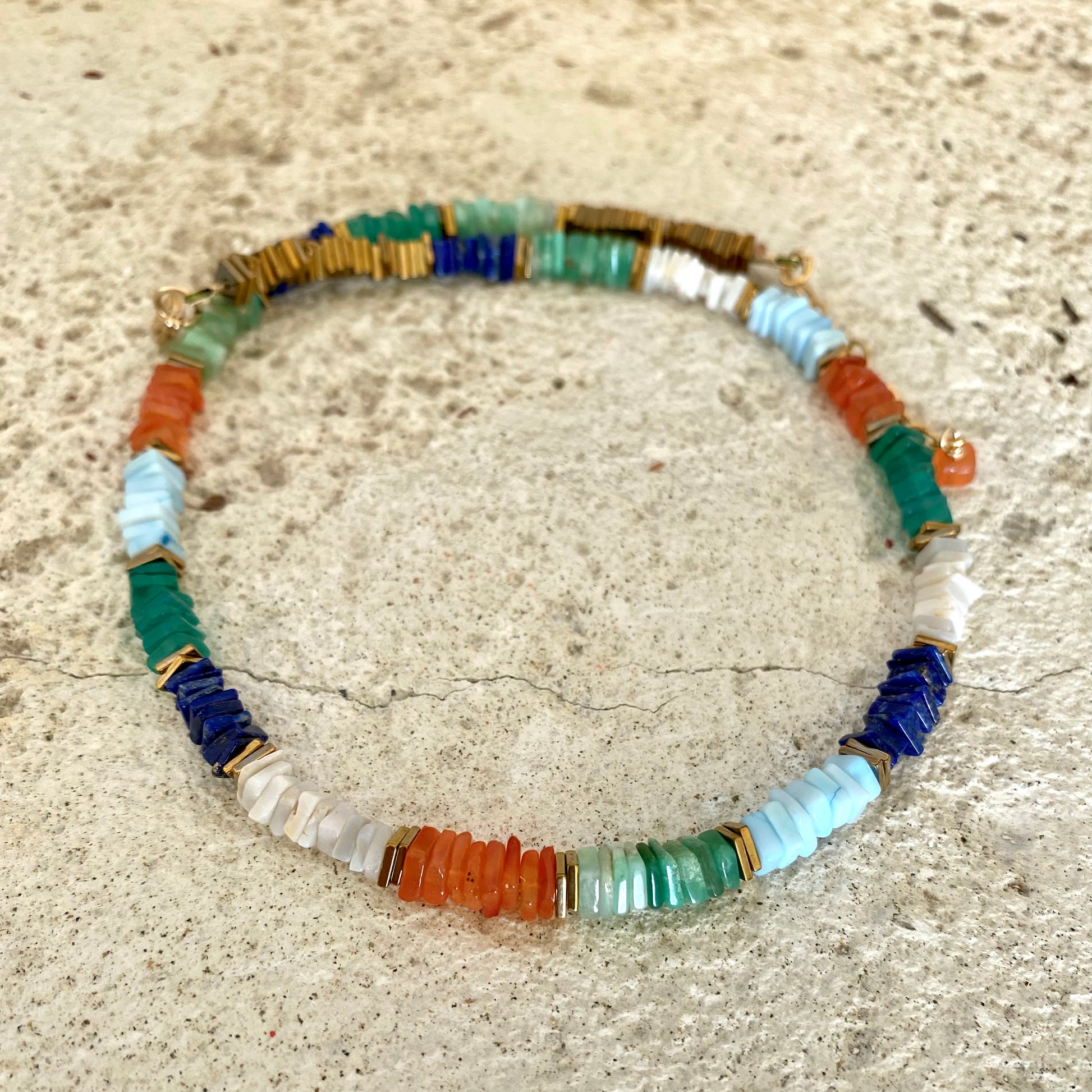 Mixed gemstone necklace with lapis lazuli and opal displayed flat with square gemstone beads