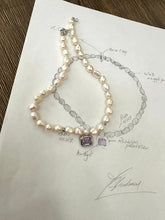 Lade das Bild in den Galerie-Viewer, White nugget pearl necklace with amethyst pendant design sketch and necklace laid out on paper.
