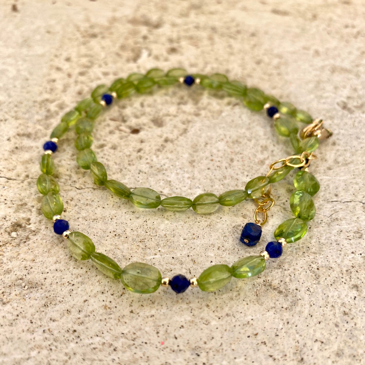 Peridot lapis necklace featuring faceted peridot and lapis lazuli beads, showcasing vibrant colors and elegance.