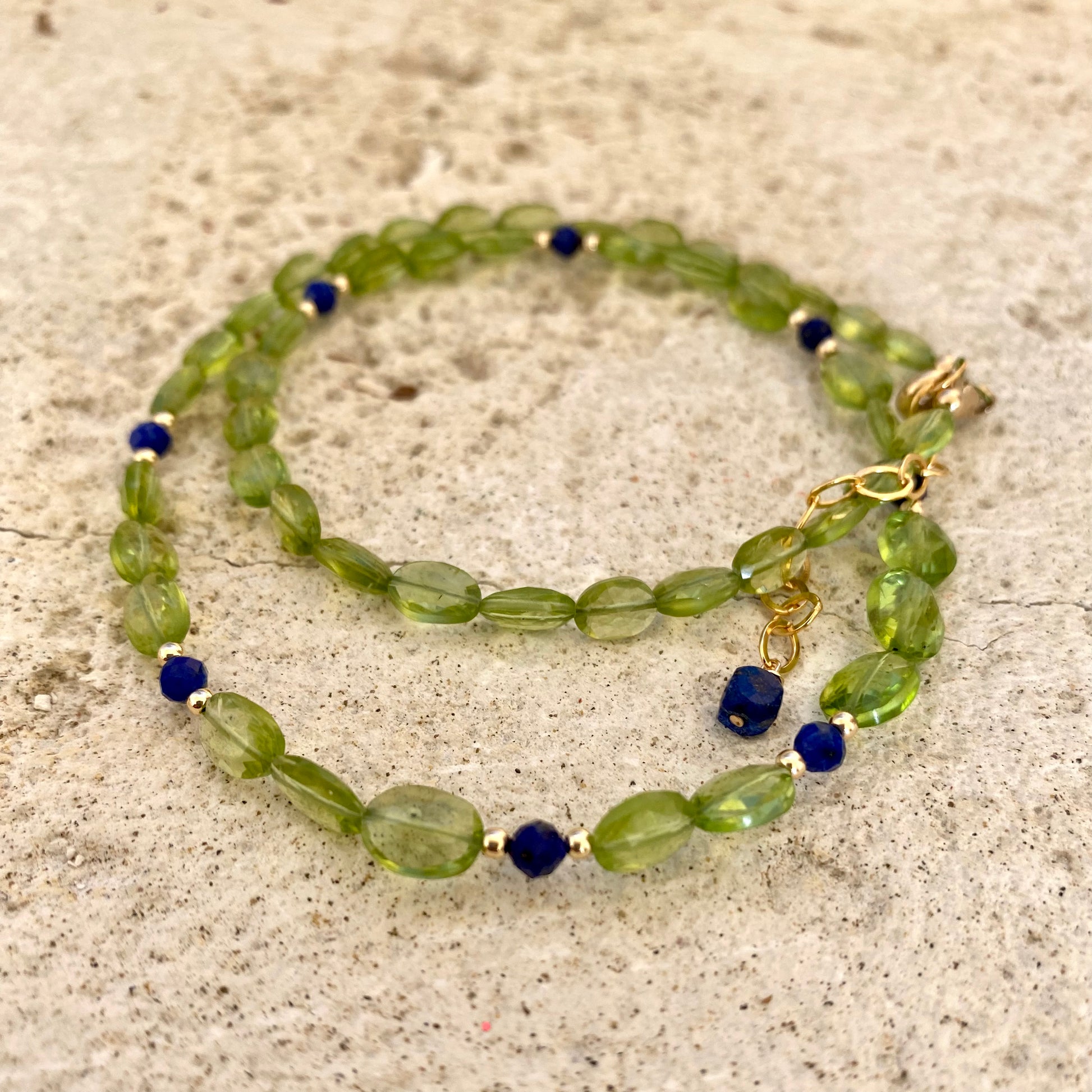 Peridot lapis necklace featuring faceted peridot and lapis lazuli beads, showcasing vibrant colors and elegance.