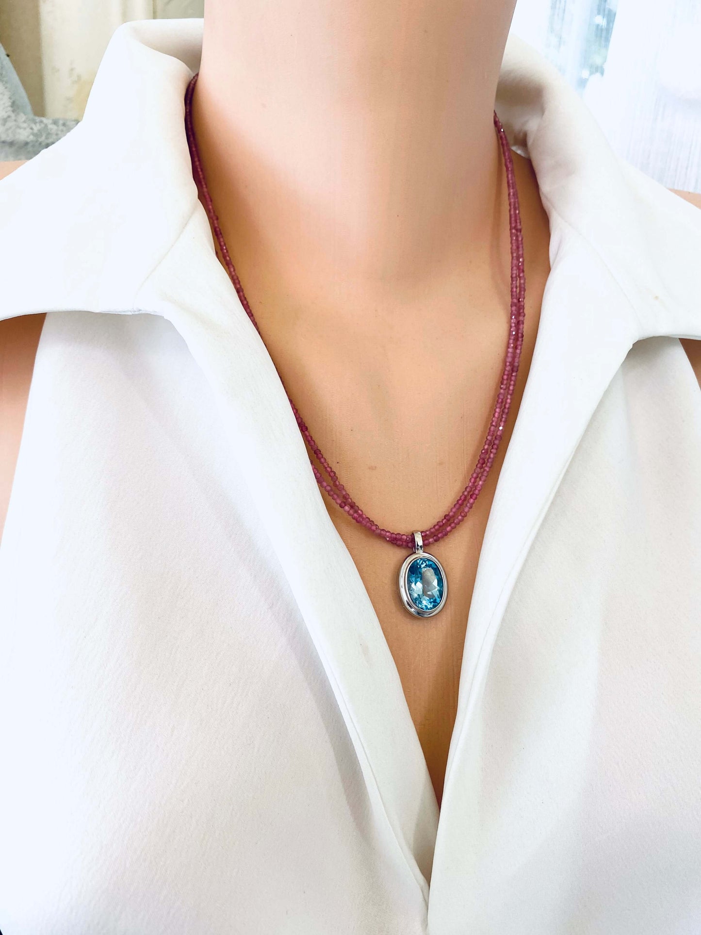 Pink Tourmaline Blue Topaz Pendant displayed on a model, showcasing handcrafted December birthstone jewelry.