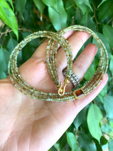Lade das Bild in den Galerie-Viewer, Green orange garnet necklace showcasing multi-strand gold vermeil with green garnet beads and orange garnet centerpiece.
