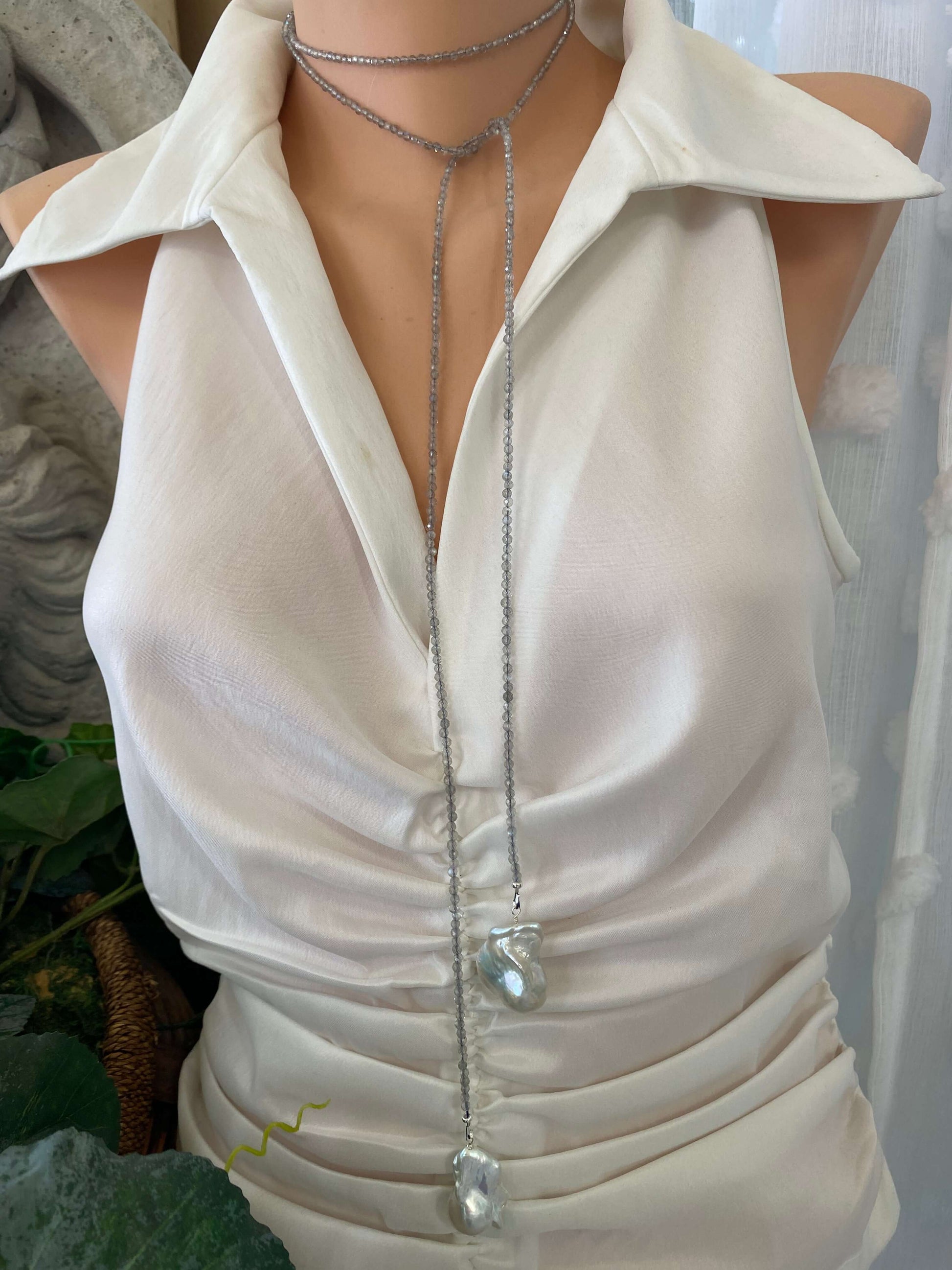 Labradorite and Baroque Pearl Necklace displayed on a mannequin, showcasing its lariat design and elegant shine.