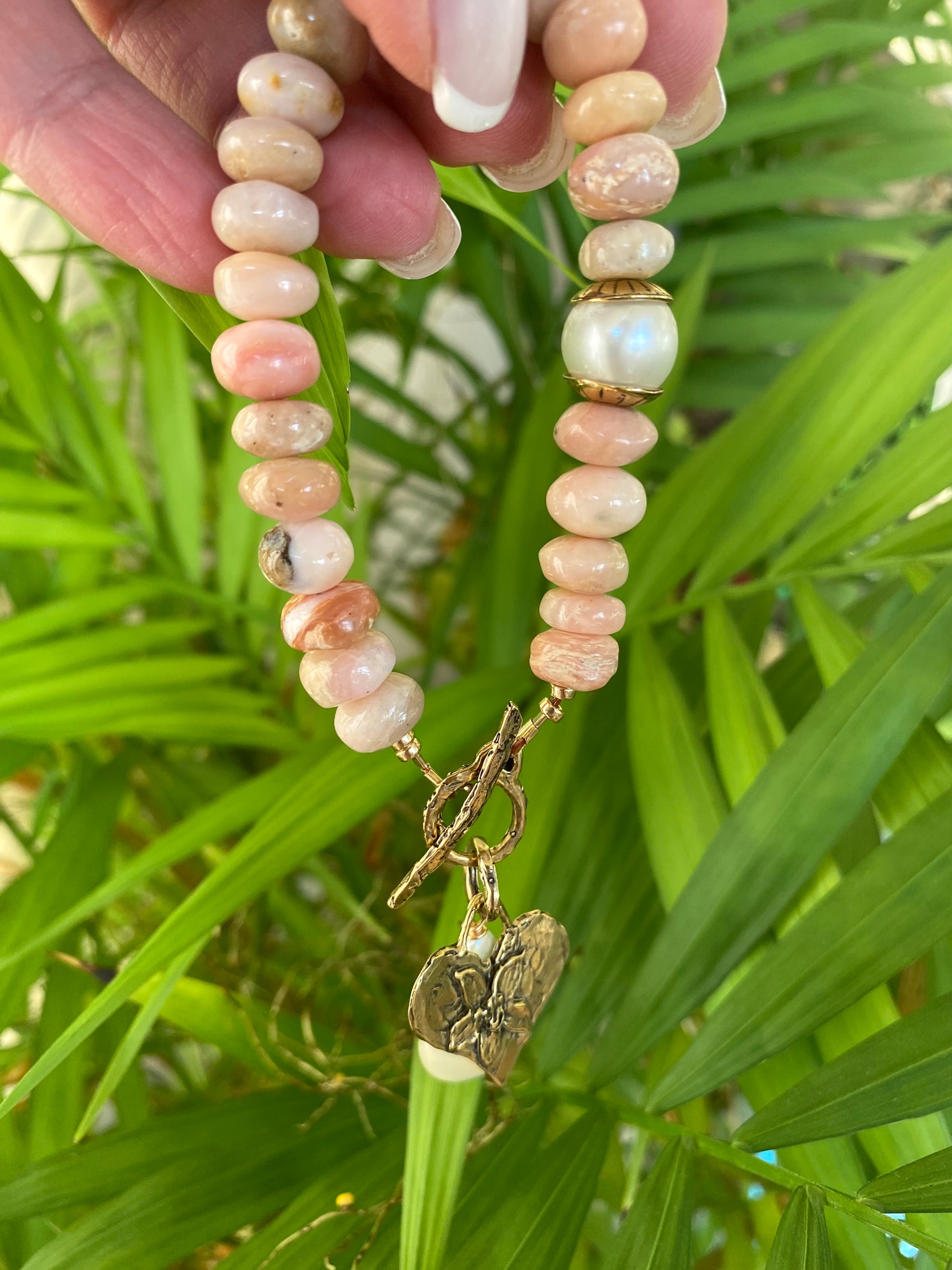 Pink opal bracelet with heart and baroque pearl charm, handcrafted with smooth pink opal beads.