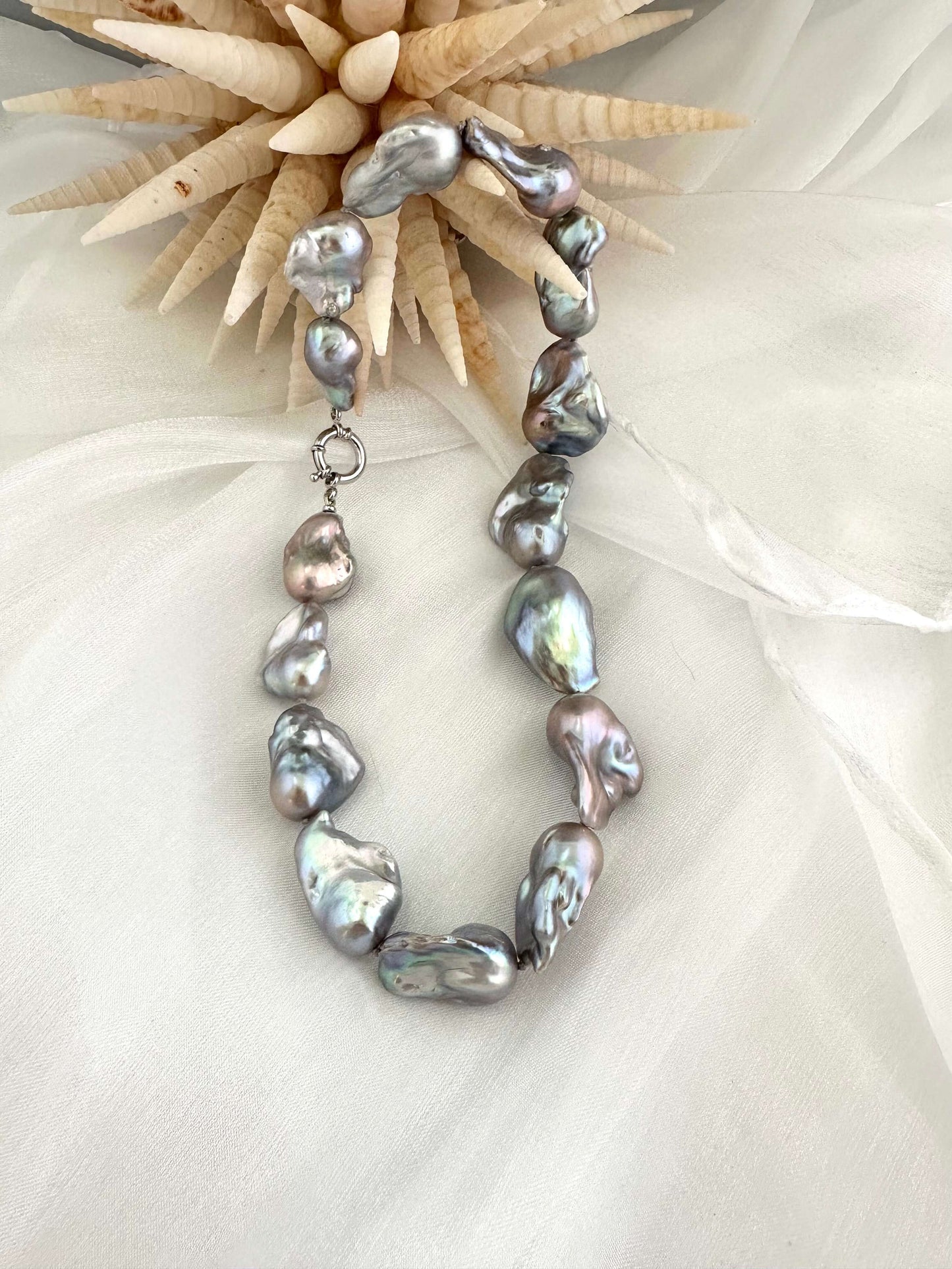 Baroque pearl necklace with silver details, handmade in Canada, featuring iridescent baroque pearls in organic shapes.