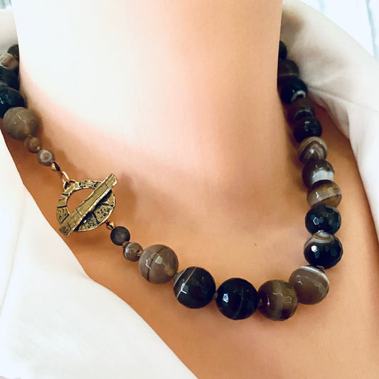Botswana agate candy necklace with gold bronze details showcasing chunky faceted beads and earthy tones.