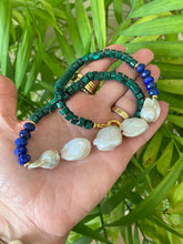 Cargar imagen en el visor de la galería, Malachite Lapis Lazuli Baroque Pearl Necklace shown outdoors with natural leaf background, handcrafted in Canada.
