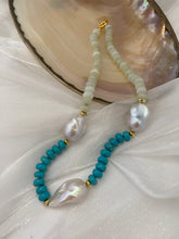 Cargar imagen en el visor de la galería, Close-up of green jade and turquoise pearl necklace on white shell backdrop
