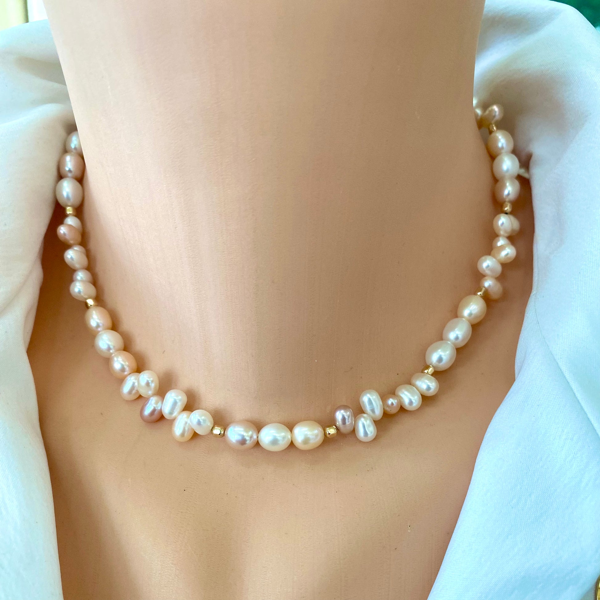 Elegant pearl toggle necklace with pastel pearls and gold accents, showcasing natural lustrous hues.