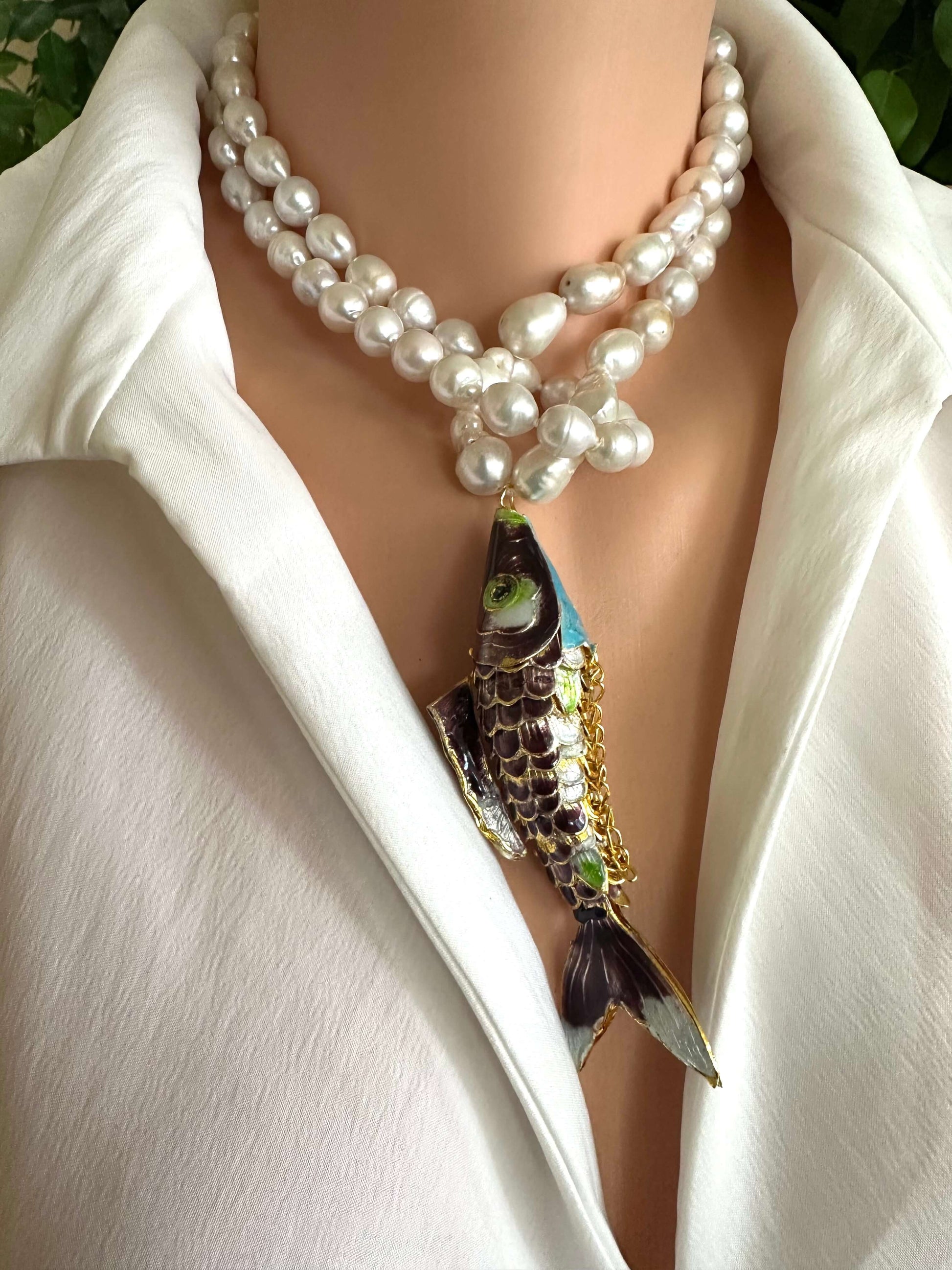 Koi fish pearl necklace featuring baroque pearls and a vibrant koi fish pendant worn by a mannequin.