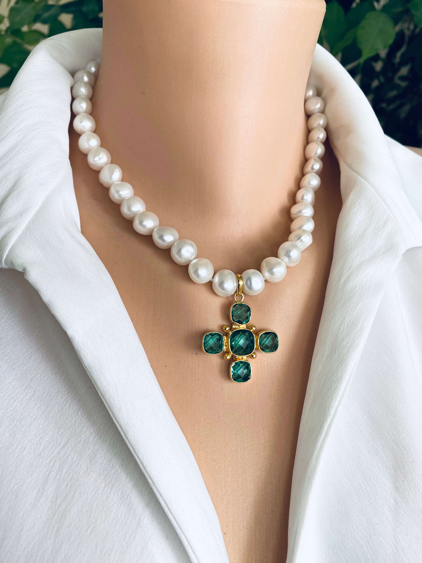 Potato pearl necklace with cross pendant featuring green quartz, elegant design with hand-knotted white freshwater pearls.