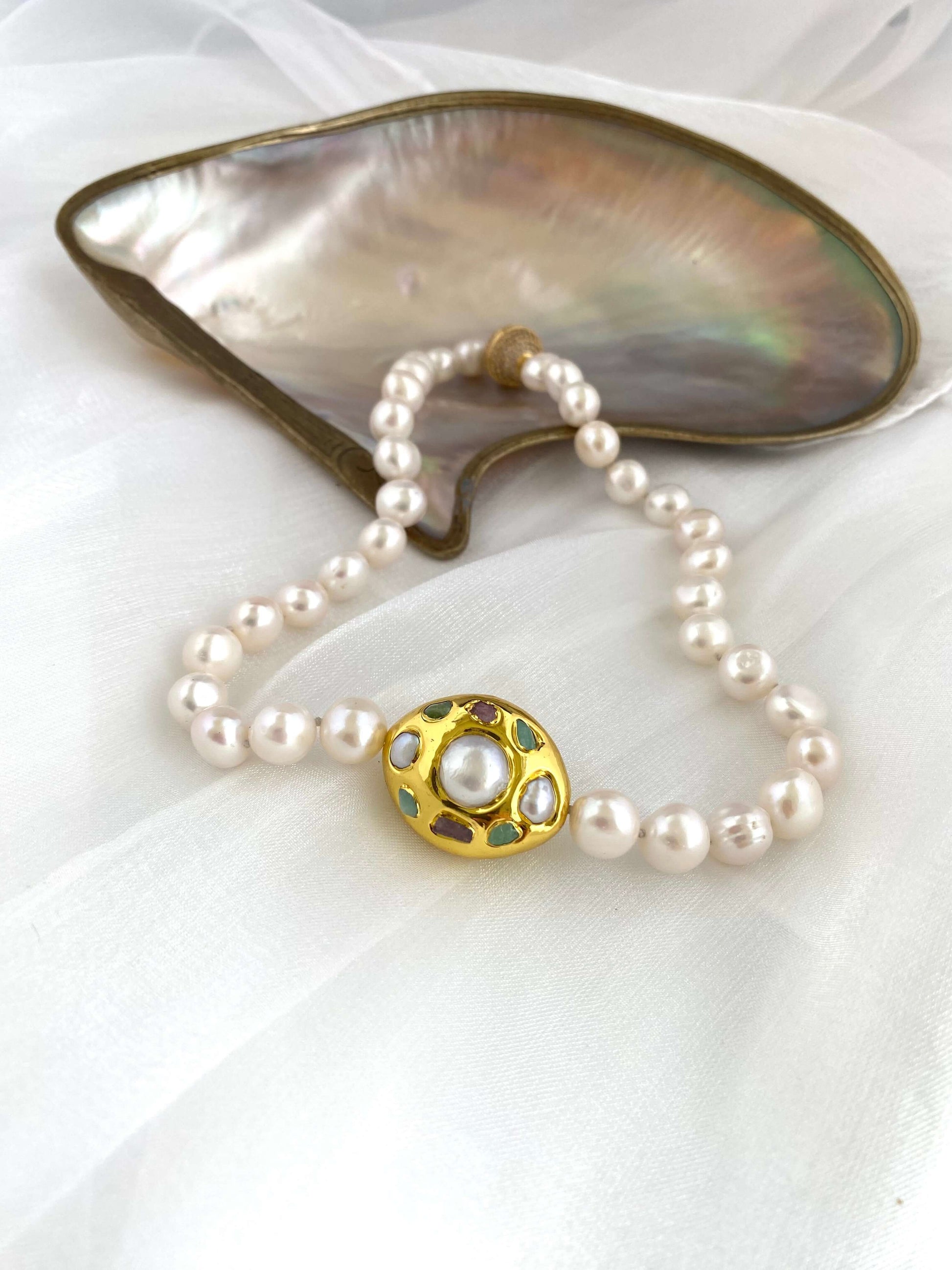 White pearl necklace with gold accent featuring hand-knotted freshwater pearls and an elegant gold focal accent.