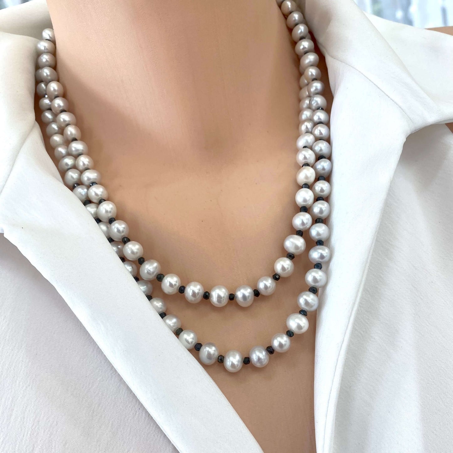 Light grey freshwater pearl necklace – Long silver & spinel design with layered pearls shown on a model.