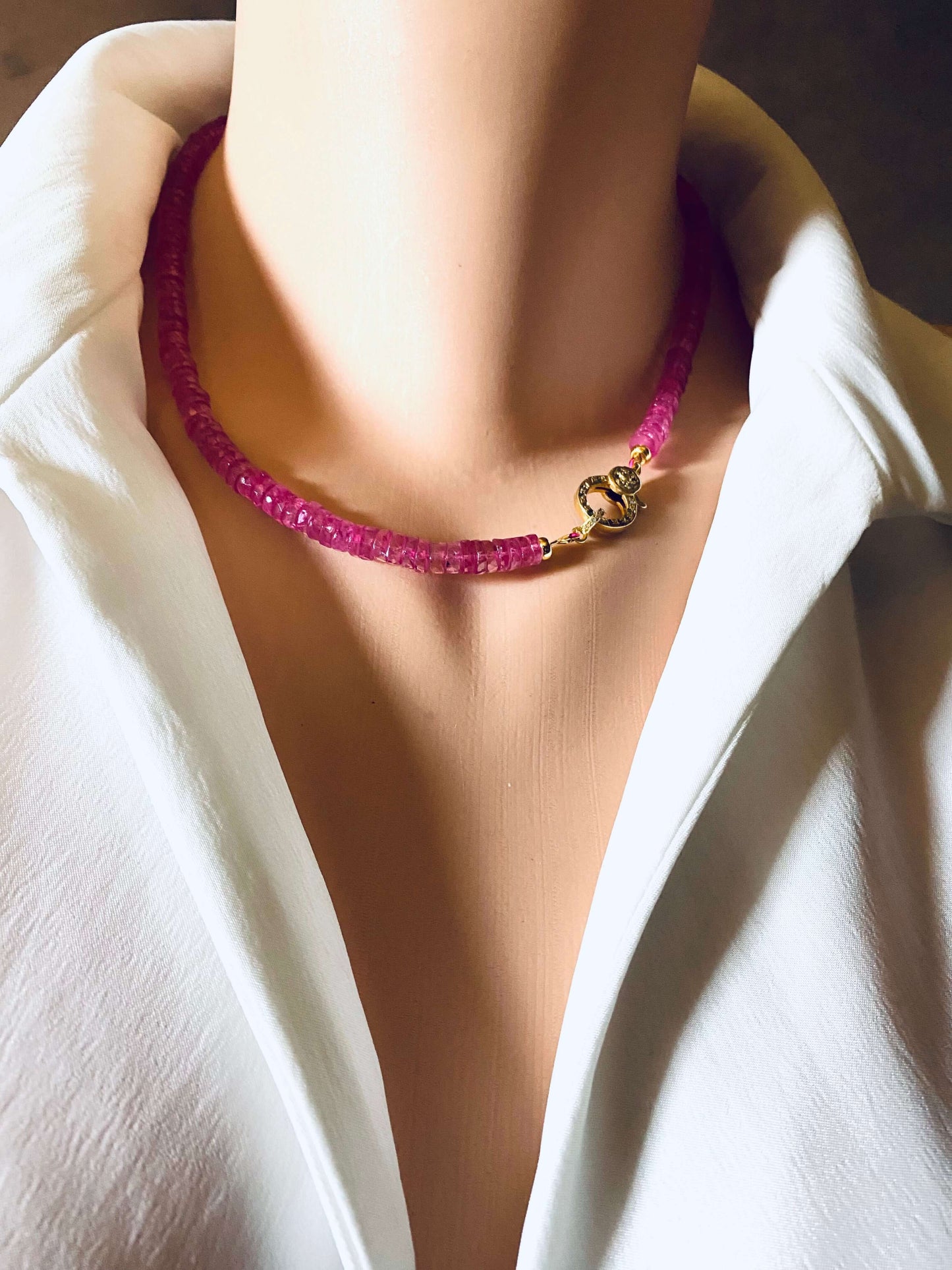 Pink topaz beaded necklace showcasing vibrant hot pink beads and gold vermeil pavé clasp, elegantly worn.