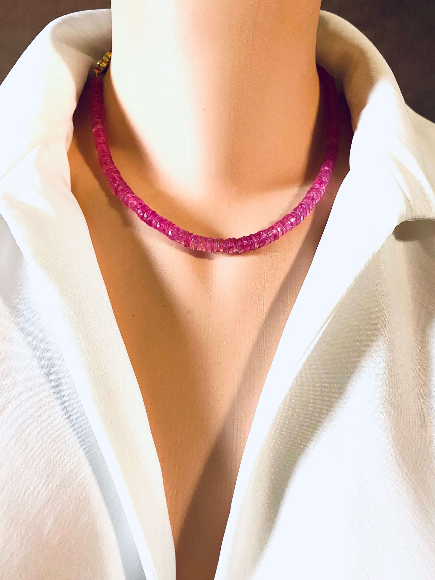 Pink topaz beaded necklace with gold vermeil pavé clasp displayed on a mannequin wearing a white shirt.