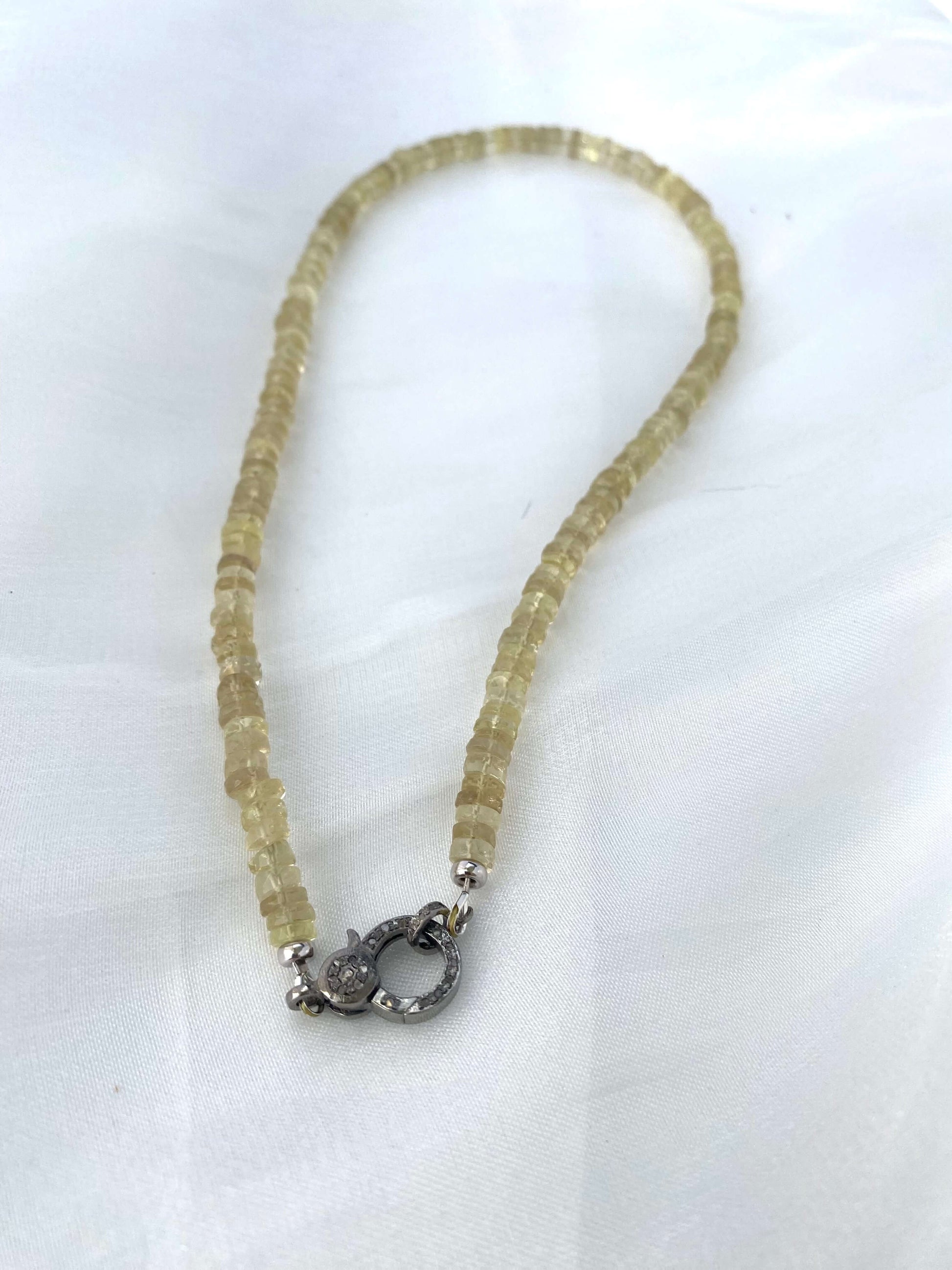 Lemon quartz beaded necklace showcasing faceted heishi beads and oxidized silver pavé clasp.